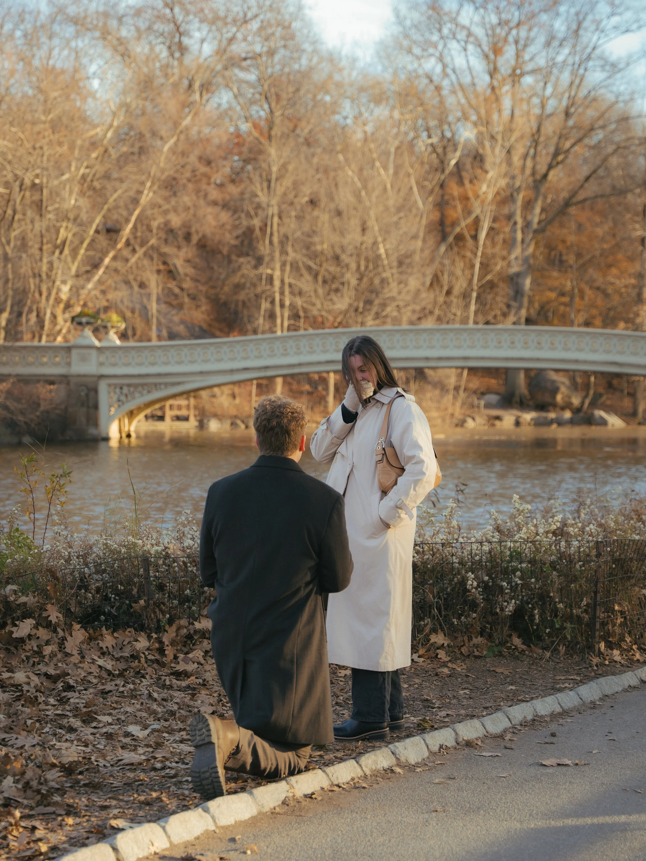 Man proposing to woman on NYC rooftop at sunset