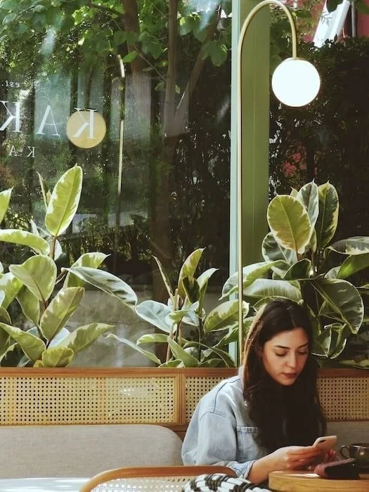 Teen on phone in cafe