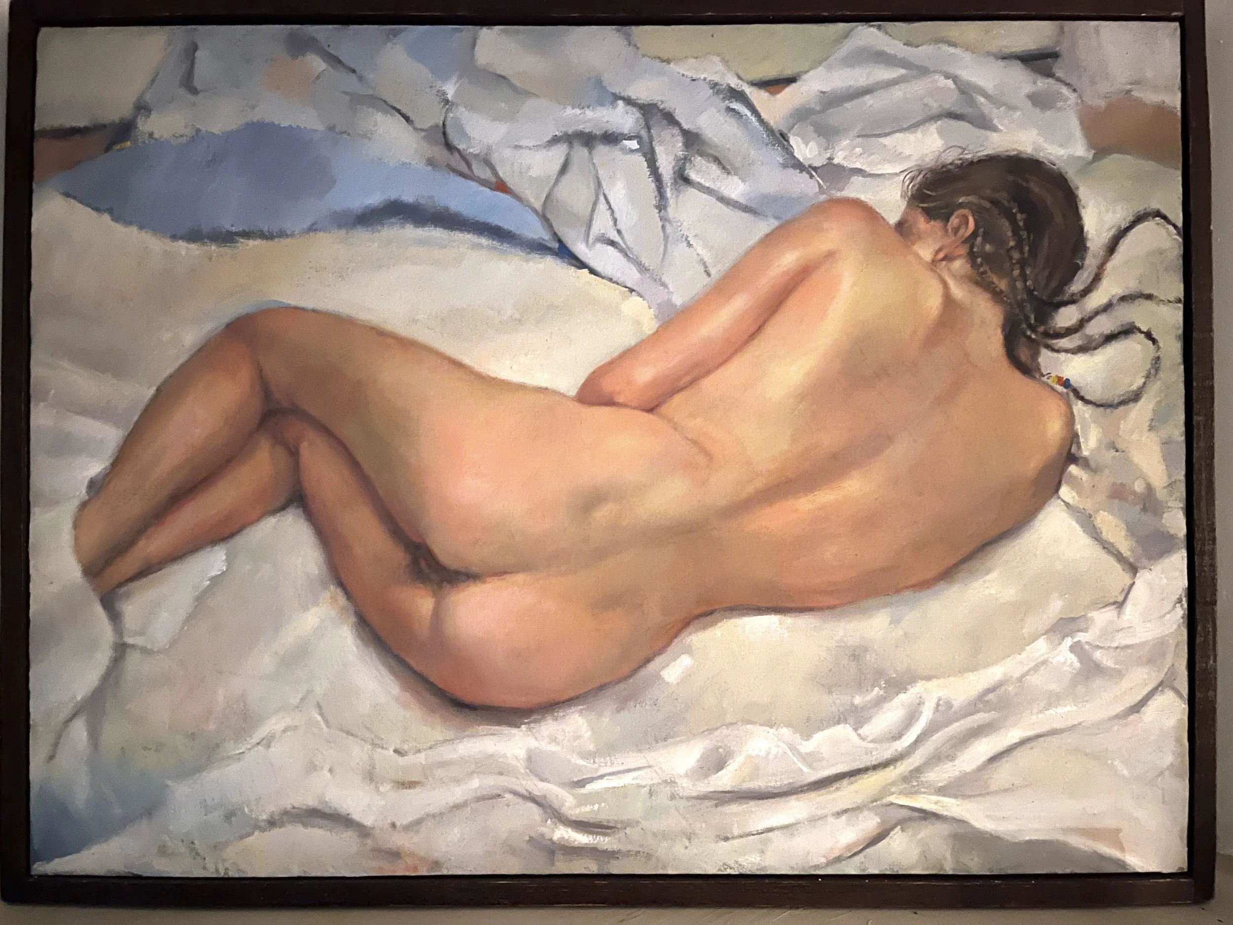 A painting of a nude woman lying on her side on a bed with white and light-colored sheets and pillows, with her back facing the viewer.