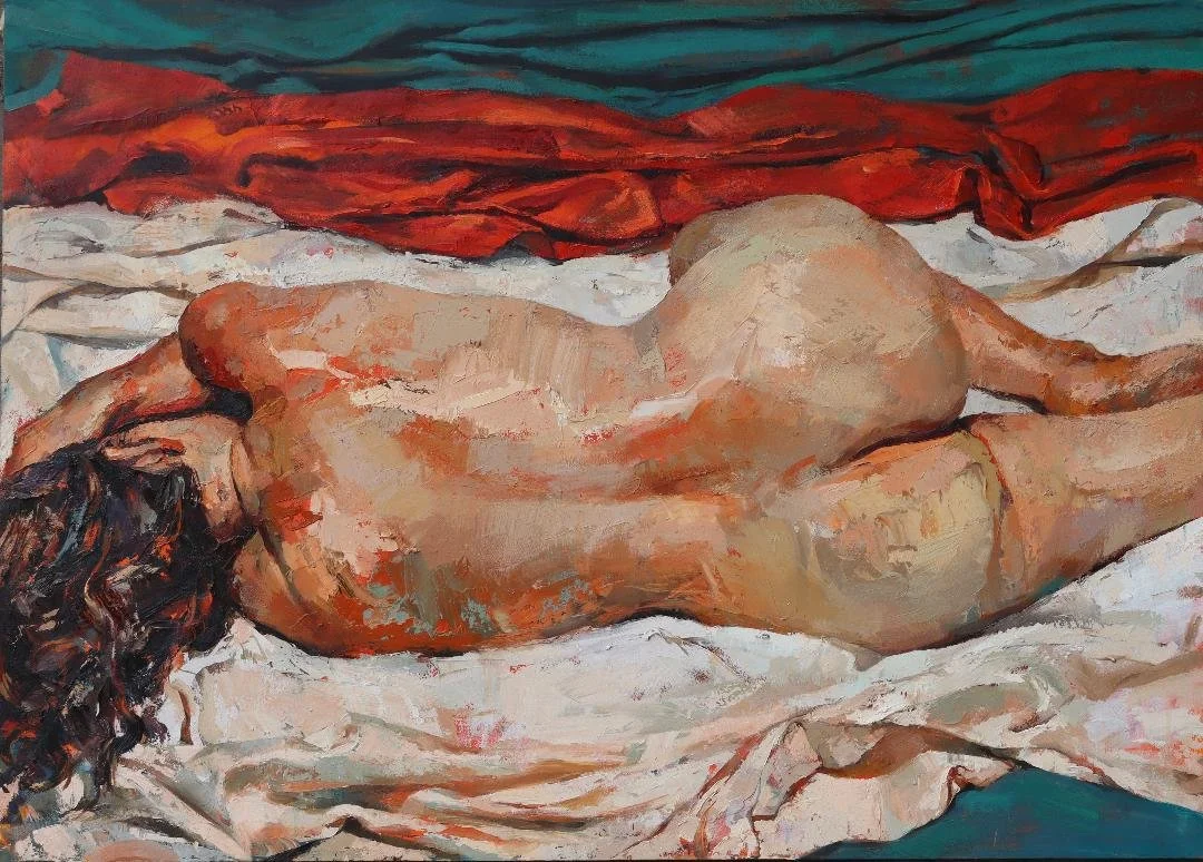 An oil painting of a nude woman lying on her side on a bed with a blanket. The woman has dark, curly hair and the background features a red landscape or rocky formation.