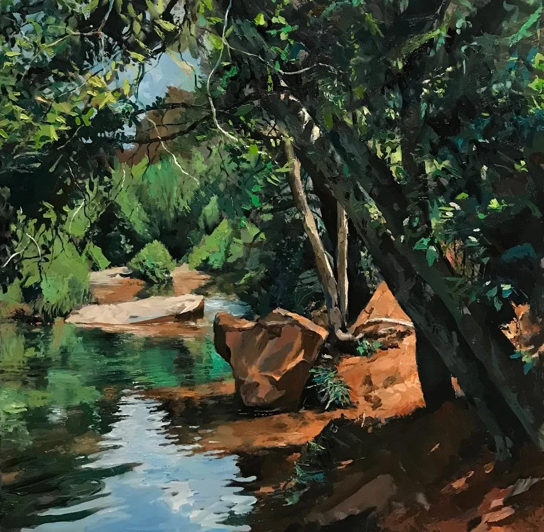 A painting of a river flowing through a forest with large rocks on the bank and trees with dense dark green leaves.