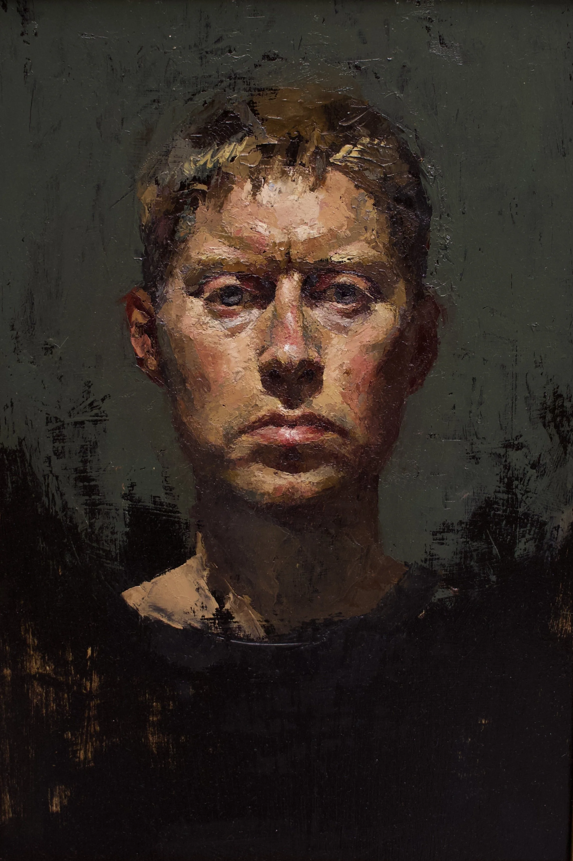 A painted portrait of a young man with short hair, looking directly forward with a serious expression. The background is dark, and the painting style is textured and expressive.