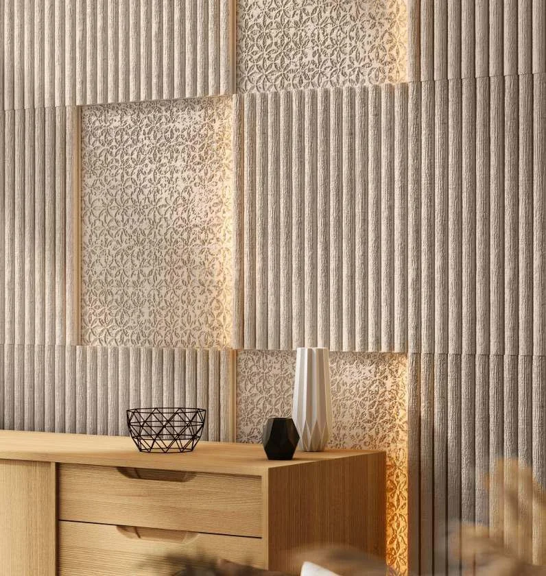 Close-up of a textured modern wall with vertical and patterned panels behind a wooden sideboard decorated with vases and a wire bowl.