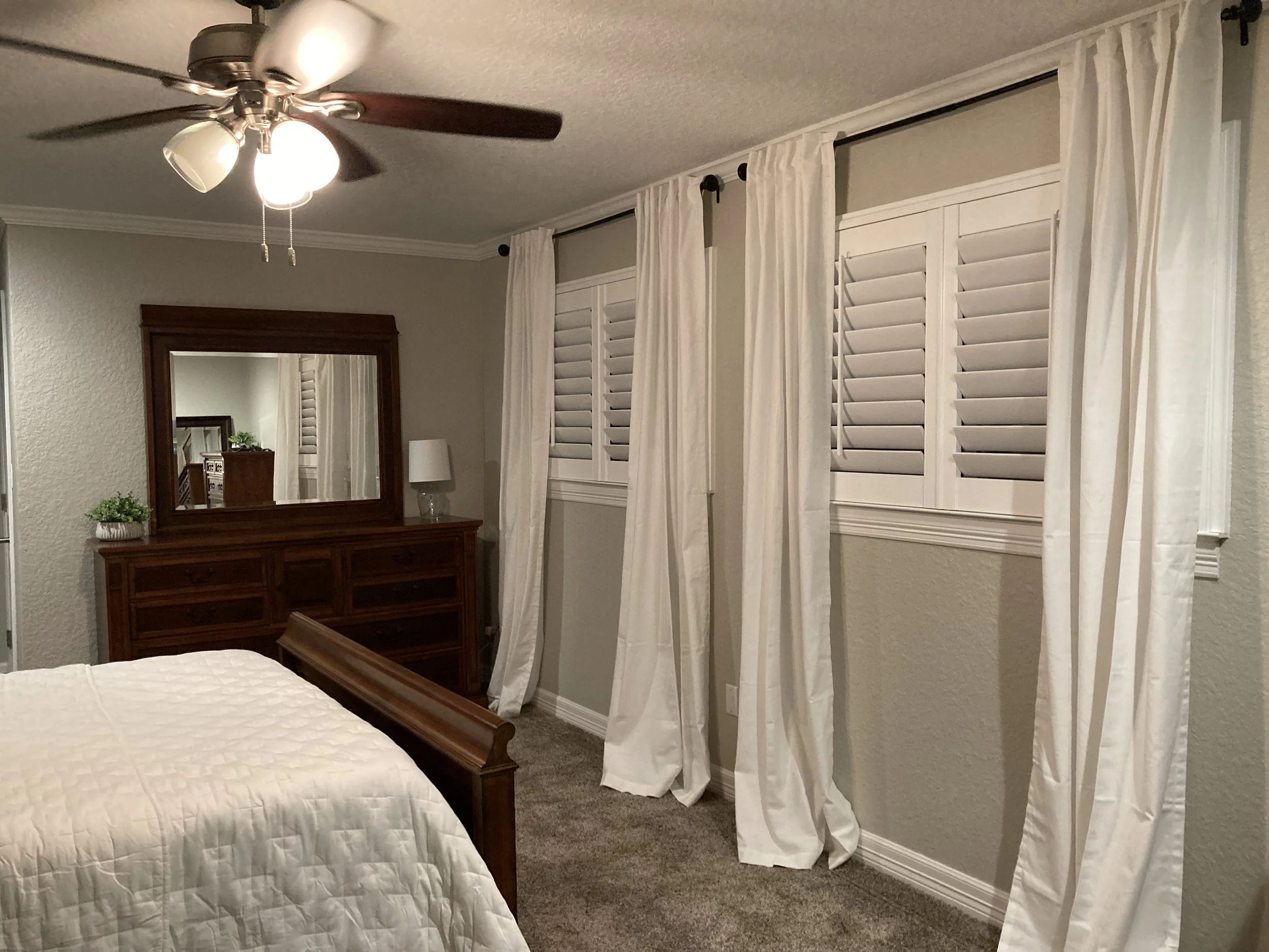 Custom Shutters framed with drapery panels