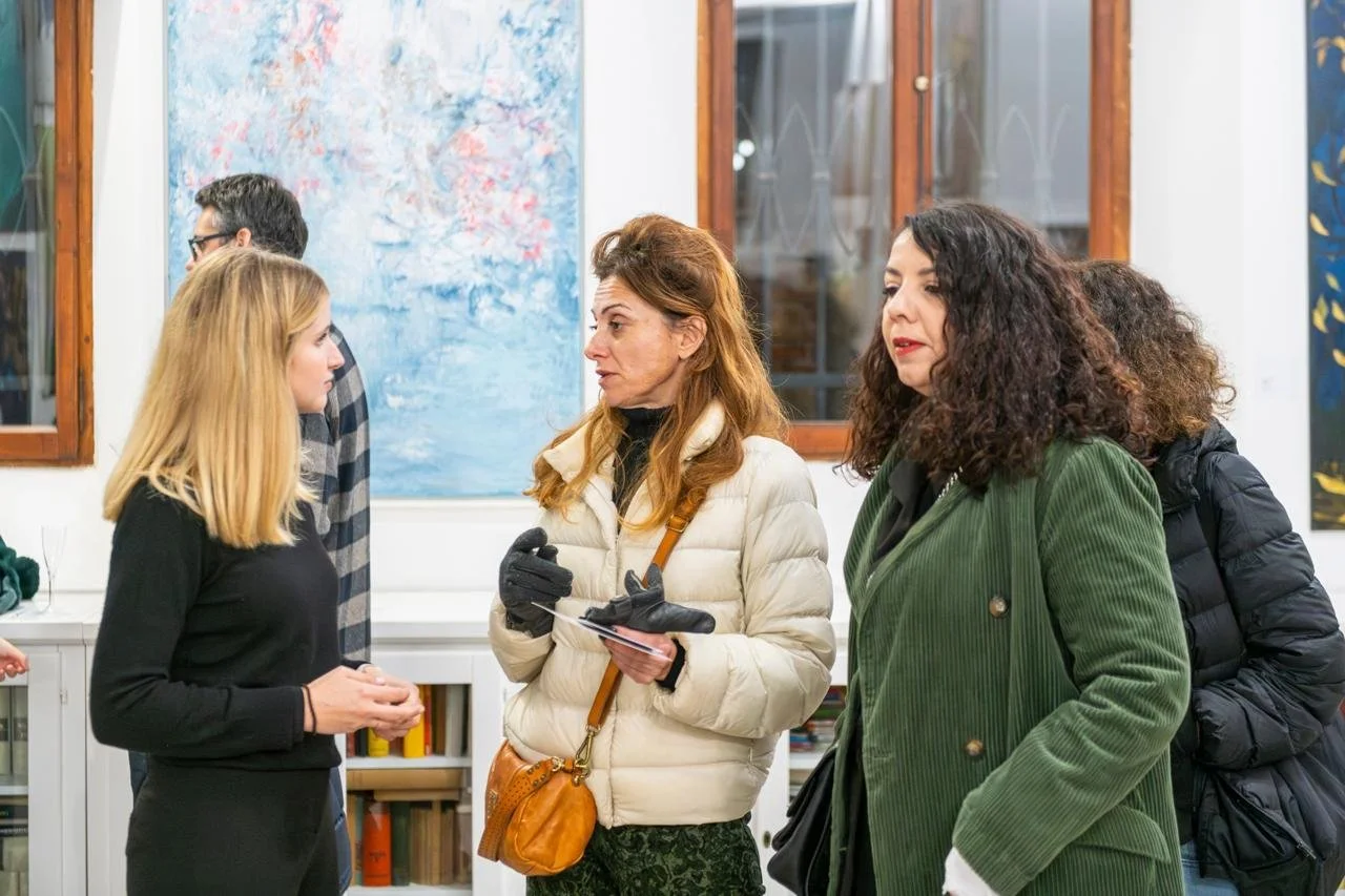 3 women talking in a gallery during the biennale in Venise, Italy, in November 2024