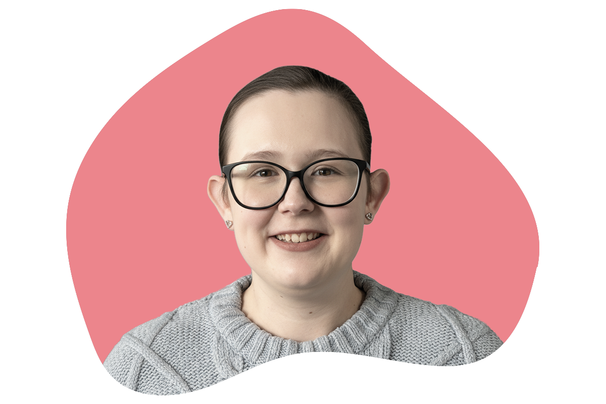 A woman with glasses and earrings smiling against a pink background with black rectangles.