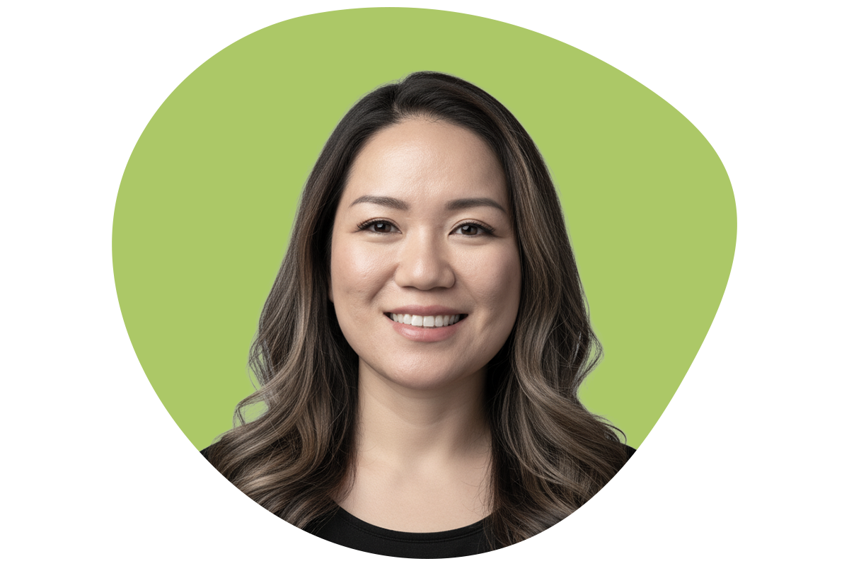 Smiling woman with wavy brown hair and light makeup, wearing a black top, against a background of black, green, and gray shapes.