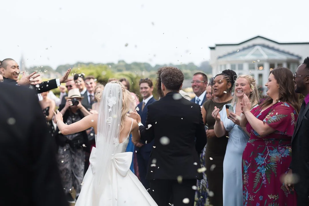 Some of the most joyful wedding days I photograph don&rsquo;t look big or flashy from the outside.

They look like a joyful confetti moment and shared laughter.
Finding ways to bring everyone together.
Exploring your favourite places side by side.

T