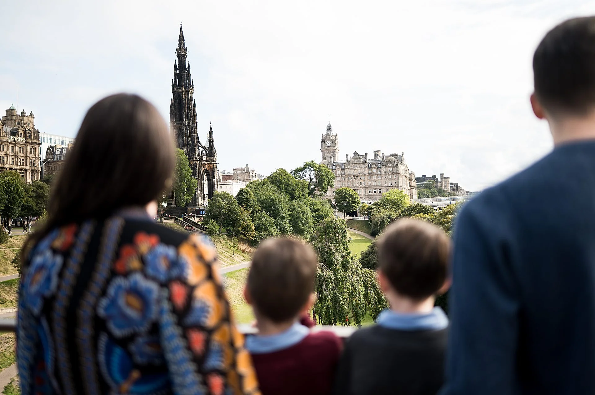 Family looking at Scott Monument Princes Street Gardens Edinburgh