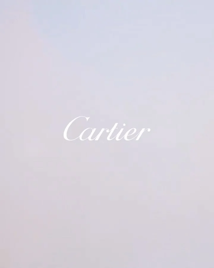 A minimalist white background with the word 'Cartier' in elegant script centered in the middle.