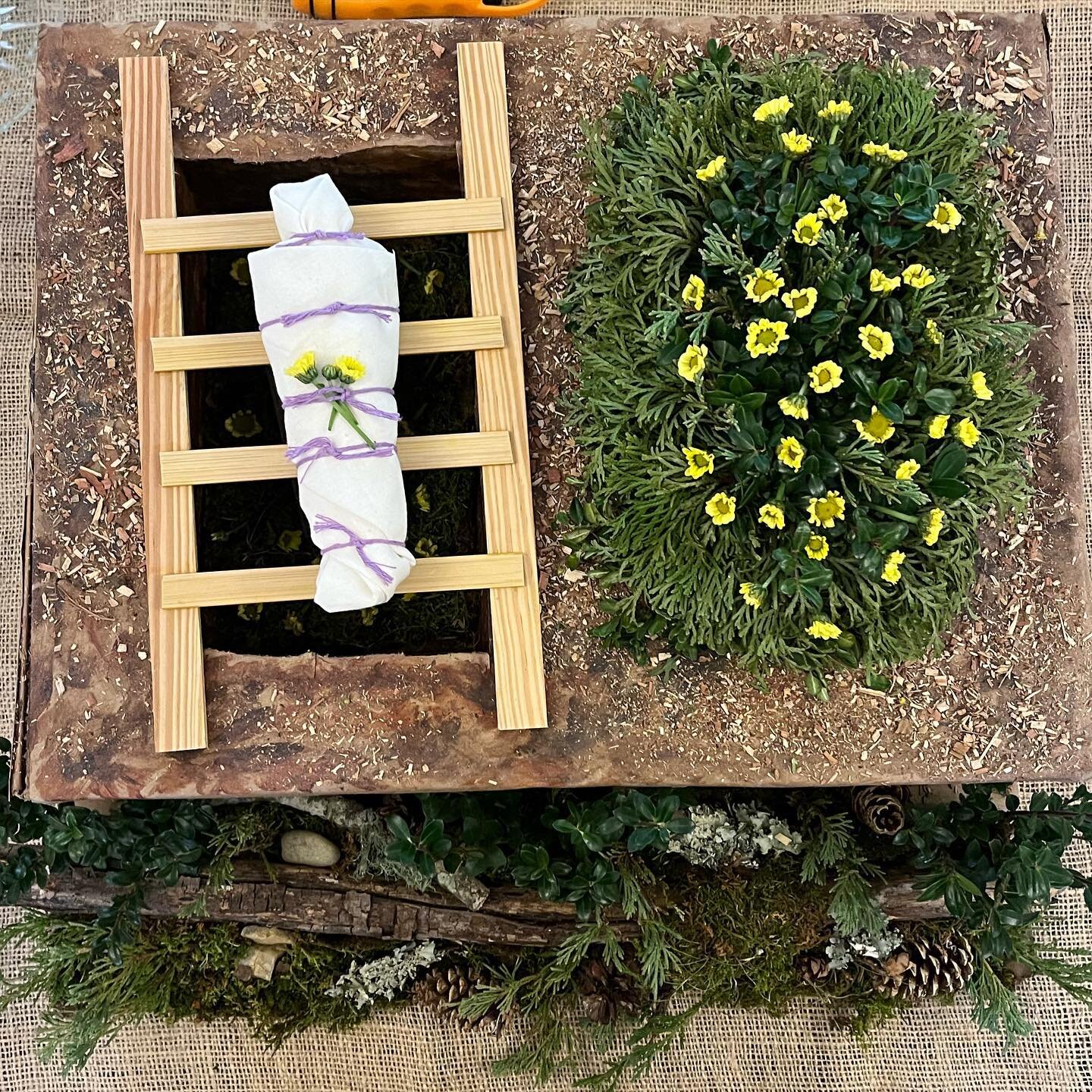 One imagining of what a green burial could look like. This represents the moment after the shrouded body has been carried to the grave and before it is lowered. Time for the graveside service and final goodbyes. 

We loved this amazing green burial m