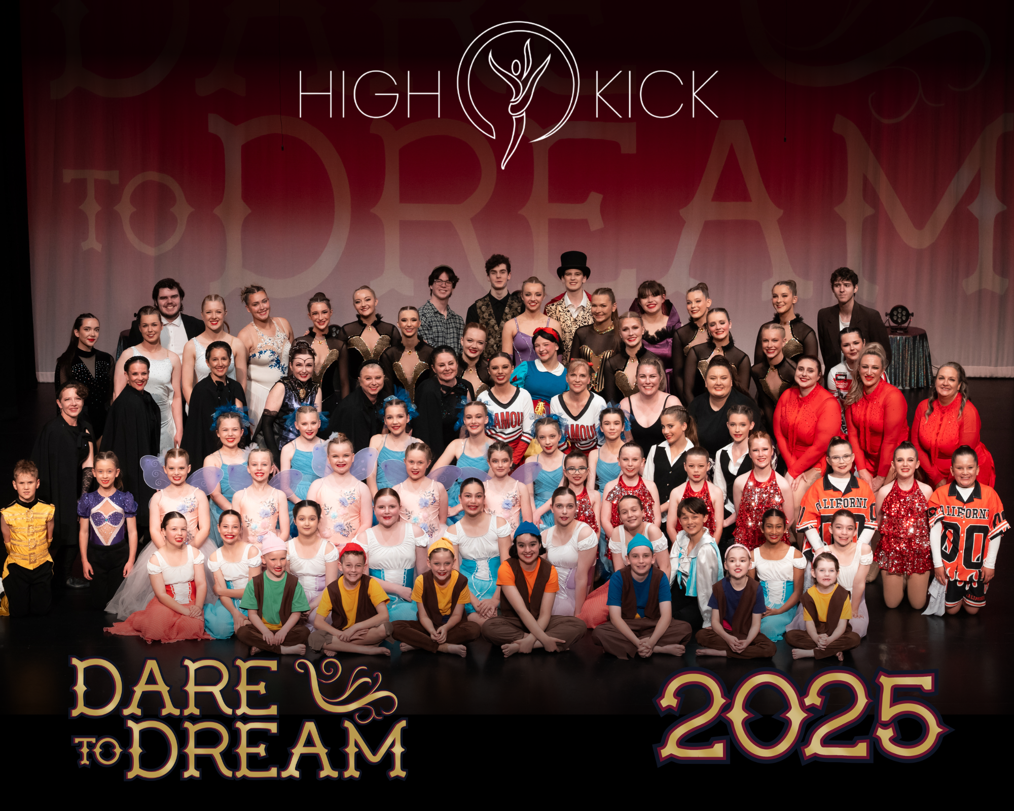 Group photo of dancers and performers on stage at a dance recital event, with a large backdrop displaying the words "High Kick" and "Dare to Dream 2025." Many children and adults in colorful costumes pose for the photo.