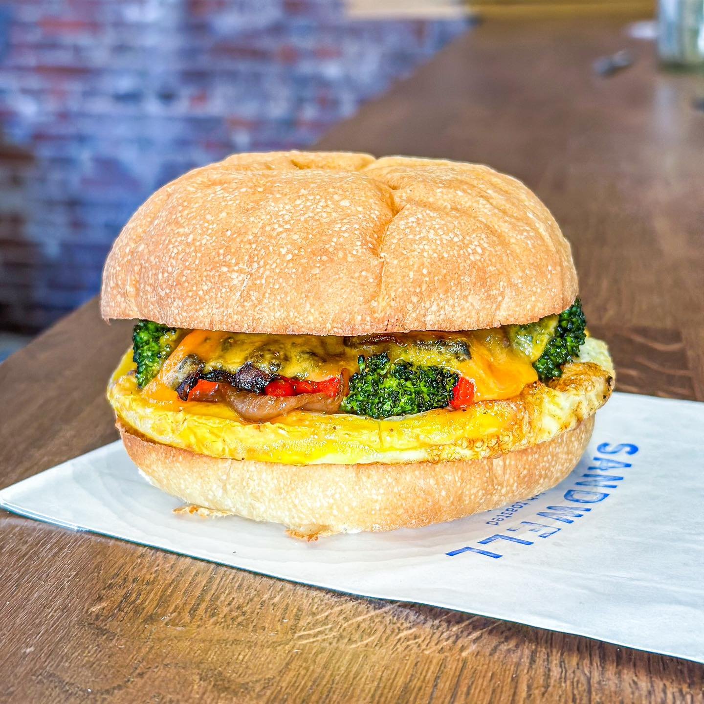 warm welcome to the menu for our breakfast veggie melt! a farmer&rsquo;s omelet on our fresh-baked kaiser rolls, packed with 🥦, spinach, roasted red 🫑, and caramelized 🧅 &amp; topped with cheddar 🧀 

stop by and say hi to the delicious veggie mel