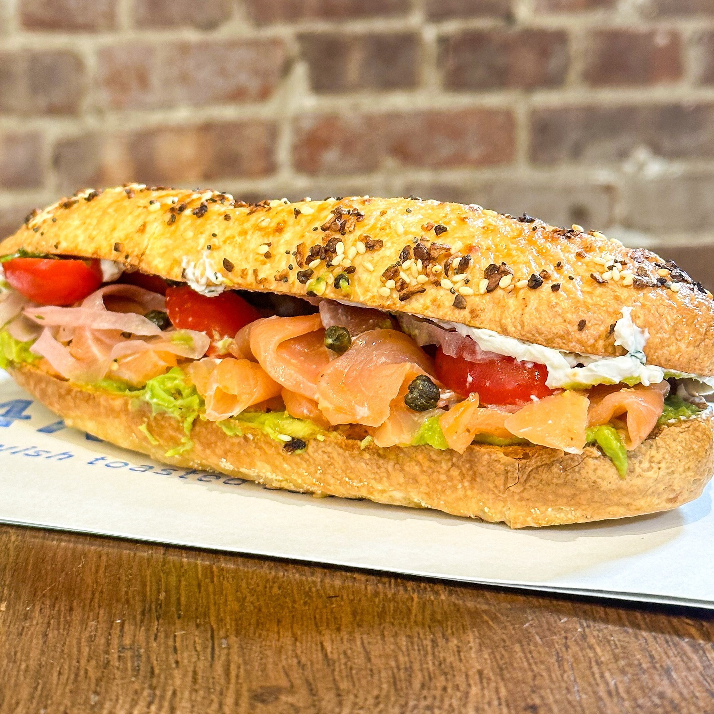 introducing The Everything HOAGEL! our hoagie x bagel crossover has the fluffiness of our signature sub rolls with the chewy magic of an everything bagel, which is toasted and then filled with our own smoked salmon, avocado mash, pickled red onions, 