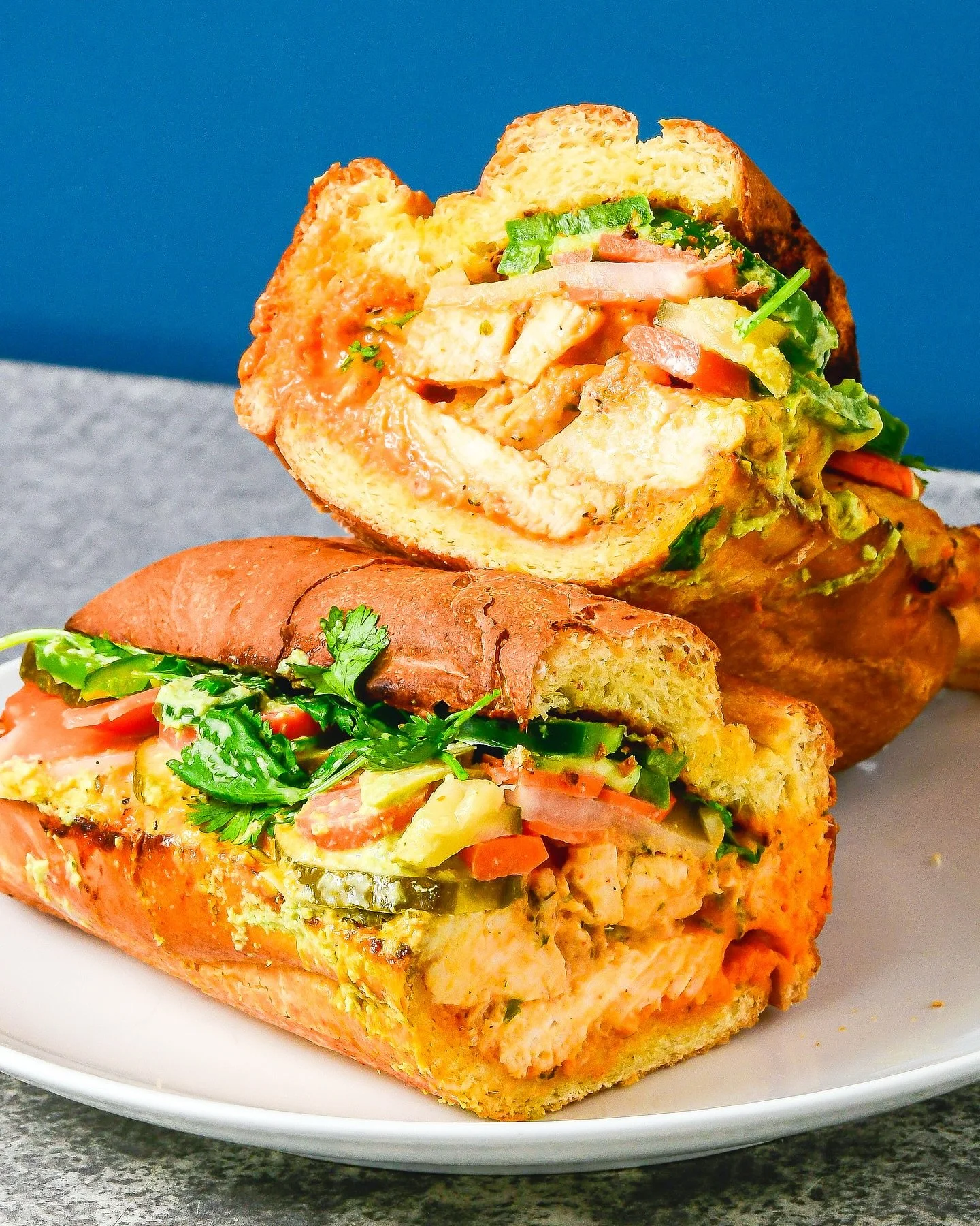 we like our chicken banh mi 🌶️ AF but not so hot it&rsquo;s just mean, so we layer in the 🔥 3 ways: sriracha coulis before toasting, a drizzle of basil jalapeno aioli right out of the oven, &amp; topped with fresh-sliced jalape&ntilde;os 🥵 

it st
