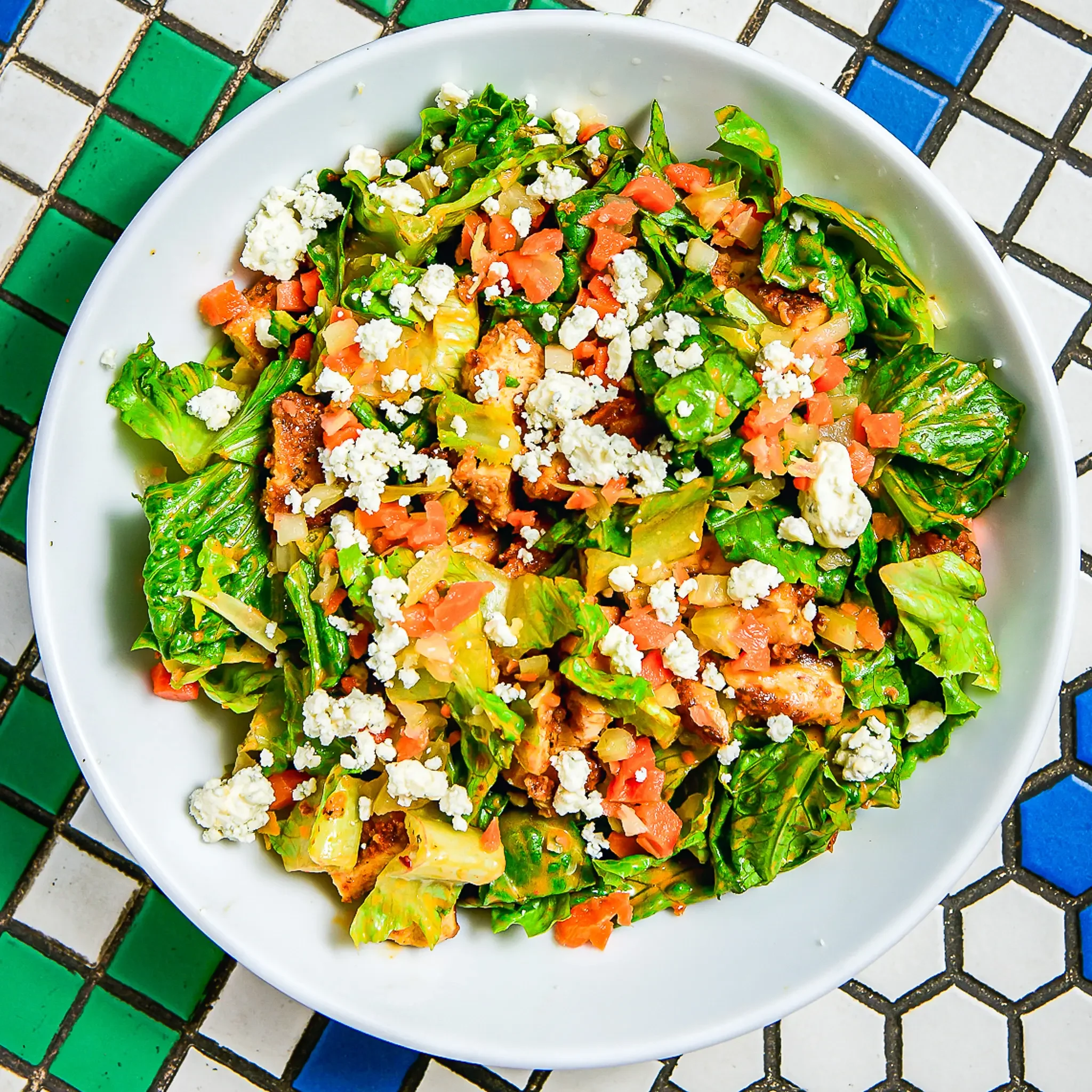Sandwell's Buffalo Chicken Salad — baked chicken cutlet with blue cheese, romaine, pickled carrots and celery, and dairy-free wing sauce dressing, available at Sandwell sandwich shops in NYC