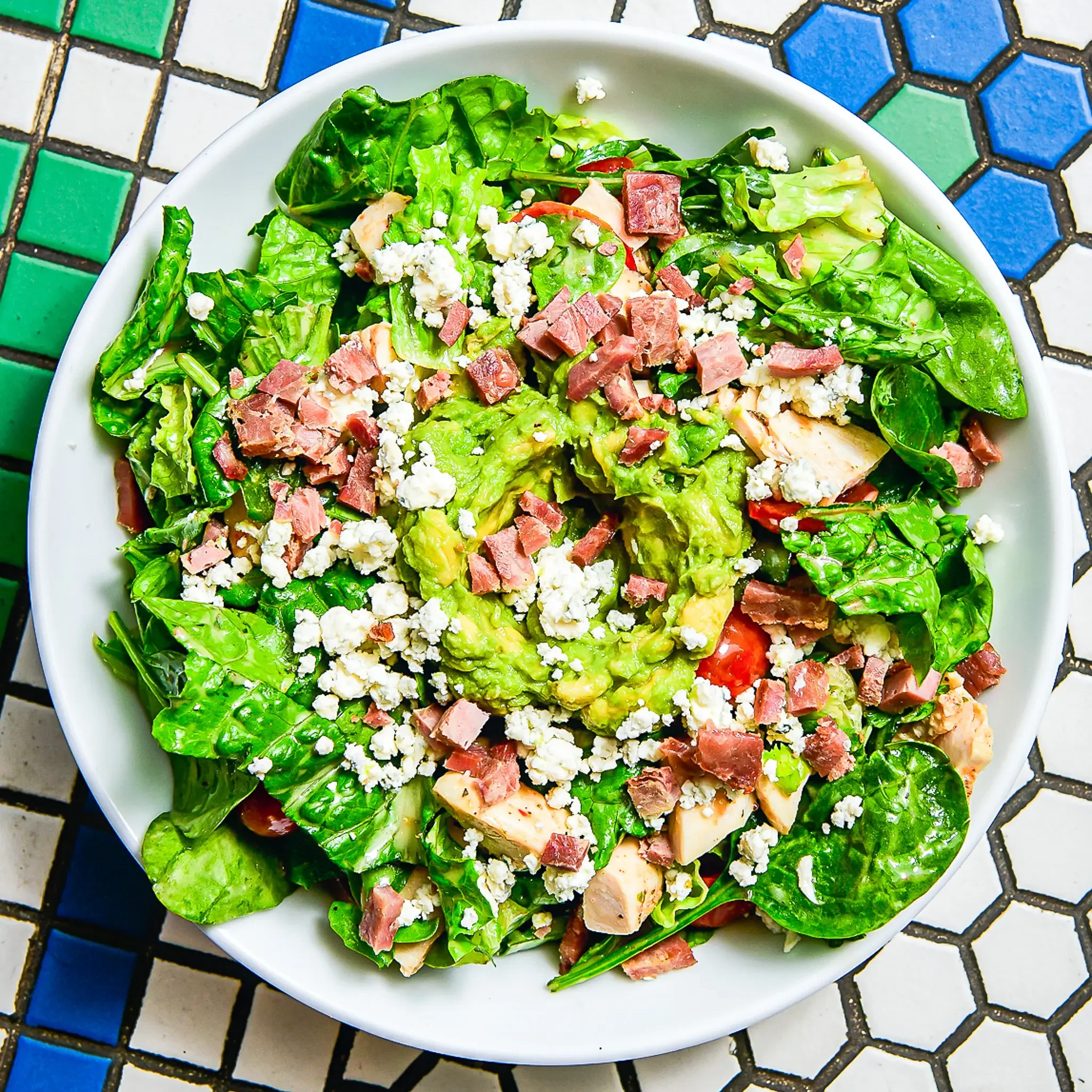 Sandwell's Maple Cobb Salad — grilled chicken with uncured turkey bacon, avocado mash, blue cheese, romaine, spinach, tomato, and maple dijon vinaigrette, available at Sandwell sandwich shops in NYC