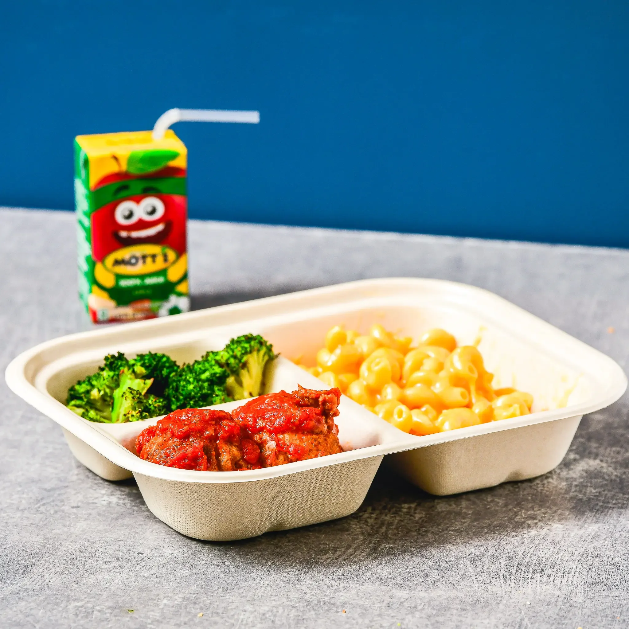 Sandwell's Kids Meal — baked chicken cutlet or turkey meatballs with mac and cheese, roasted broccoli, and apple juice, available at Sandwell sandwich shops in NYC