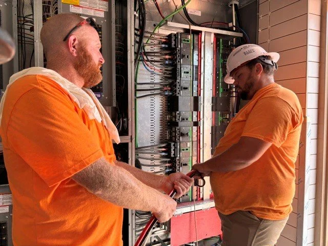 Two electricians making up wires