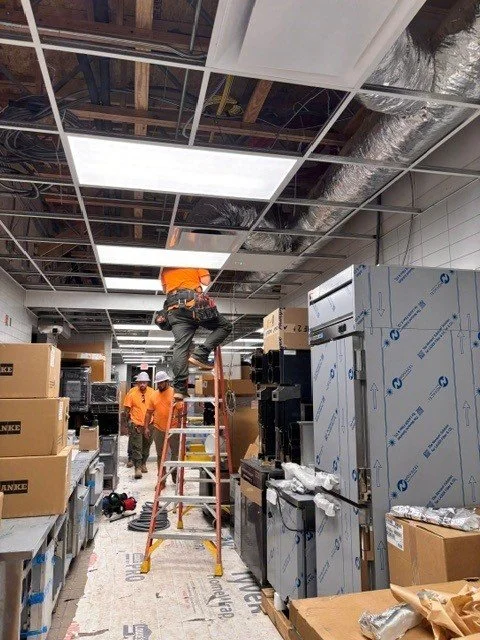 An electrician on a ladder