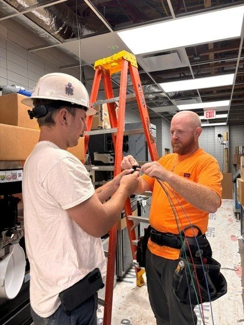 Two electricians make up wires