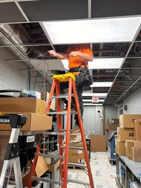 An electrician on a ladder