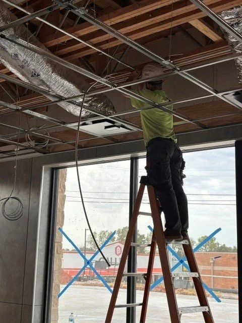 An electrician on a ladder
