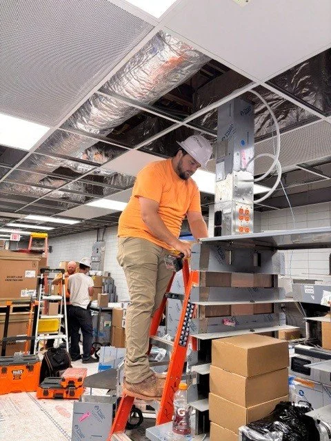 An electrician on a ladder