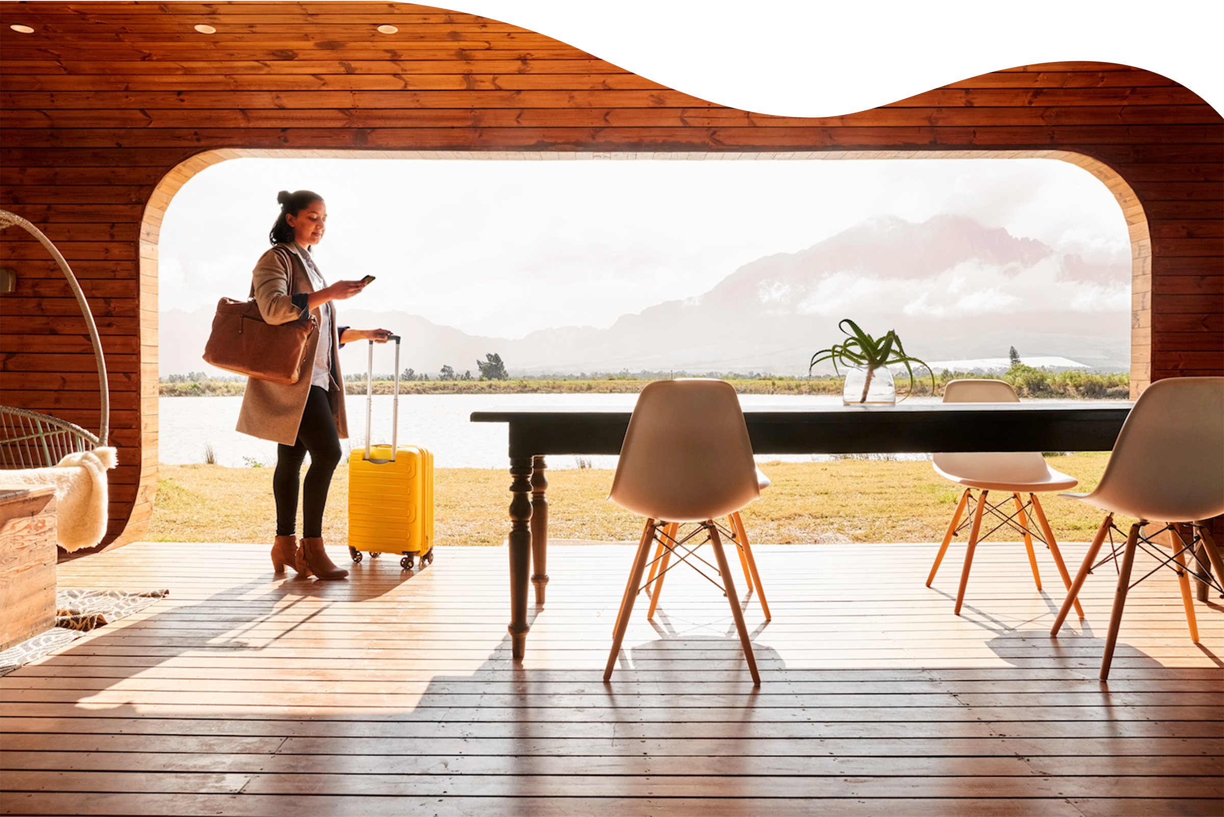 Short-term rental guest arriving at a mountain cabin with a suitcase