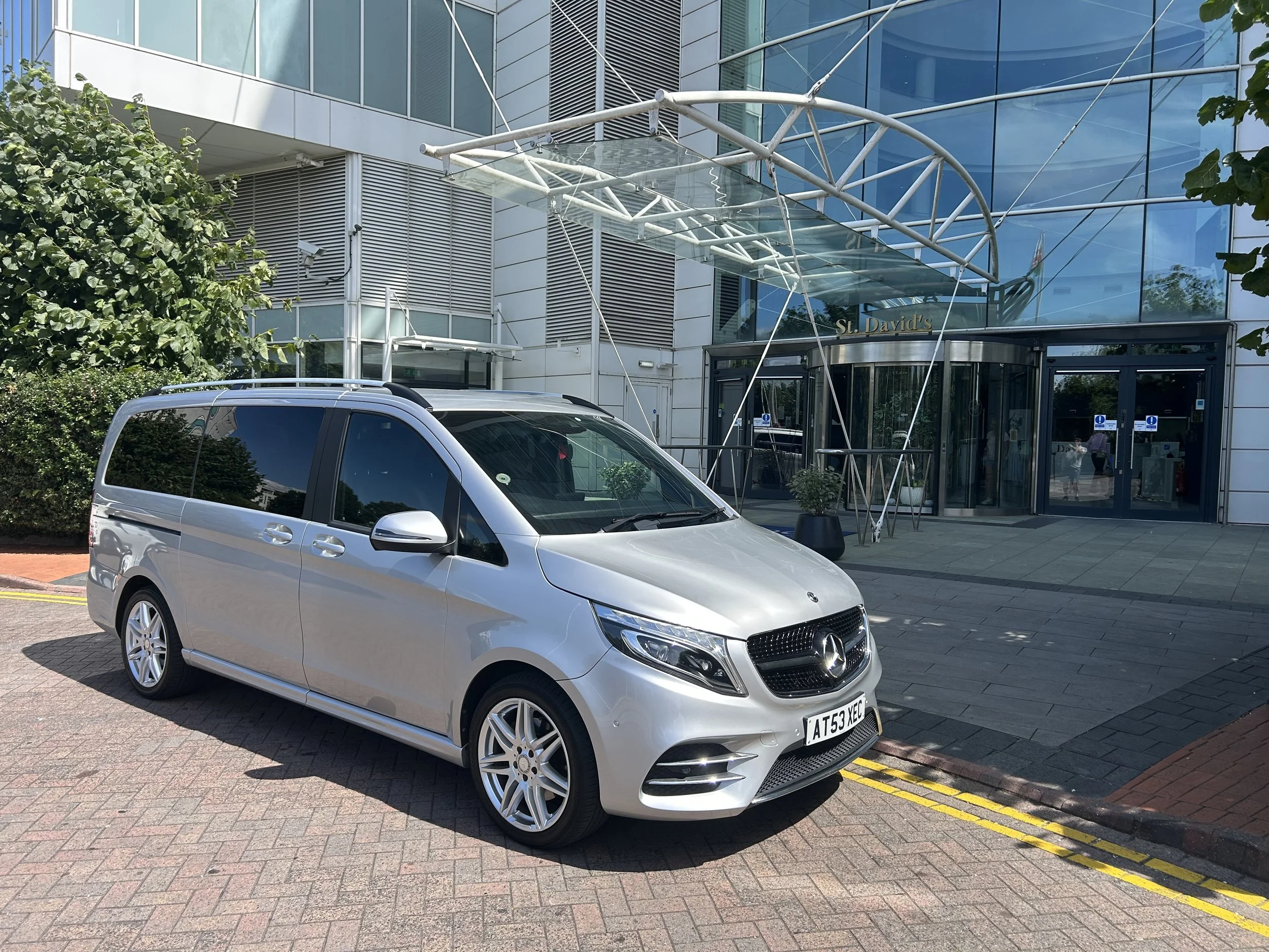 A silver Mercedes V class outside St Davids hotel Cardiff bay
