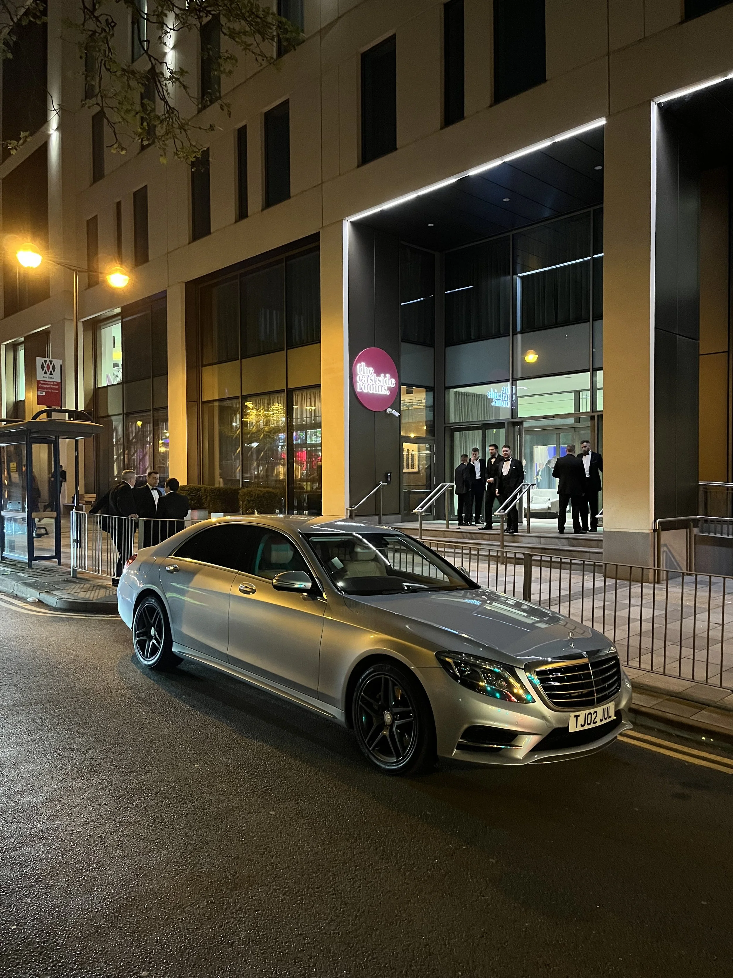 silver Mercedes s class outside a hotel