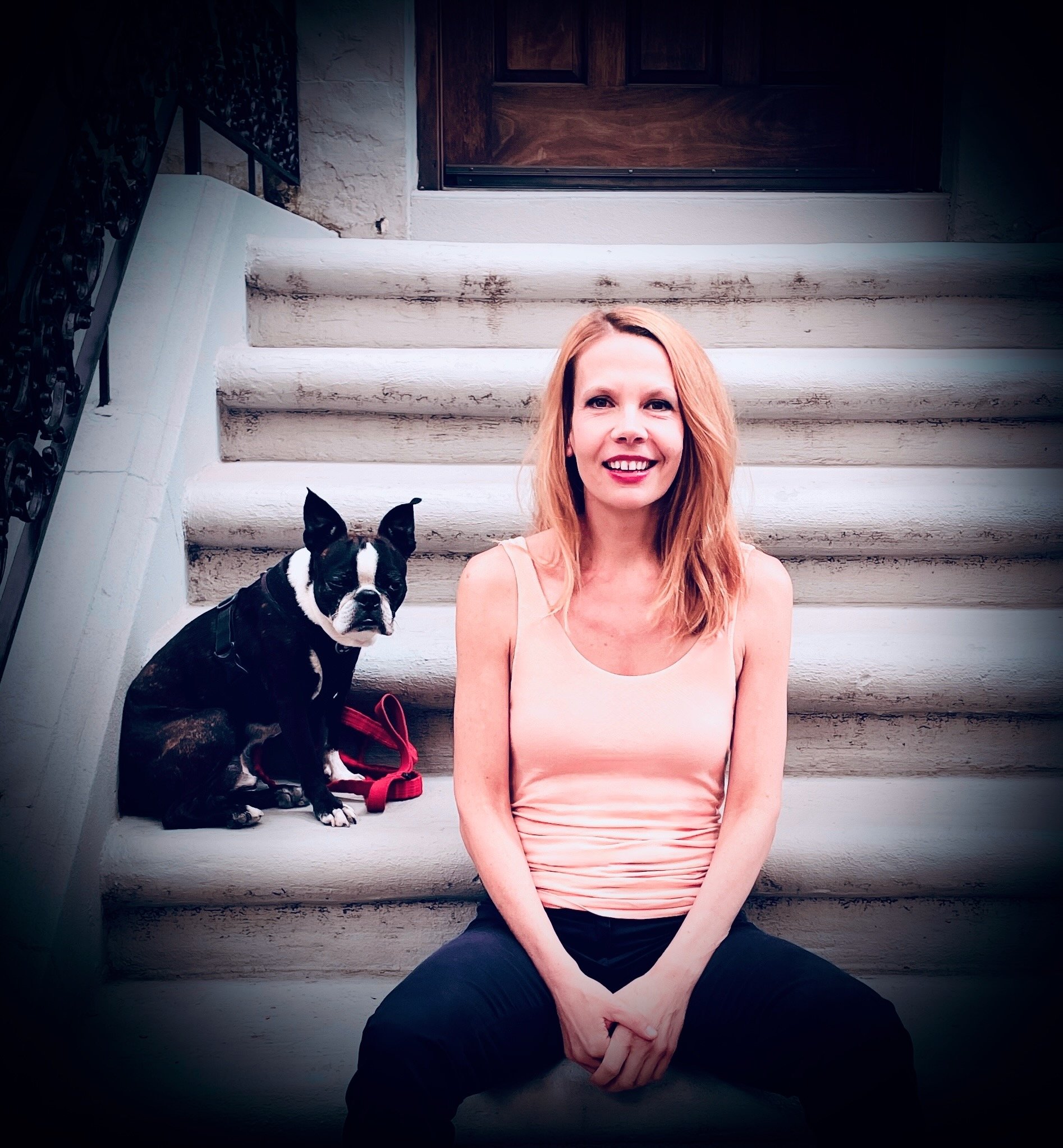 Yvonne and her dog sitting on a stoop on the Upper West Side in New York.