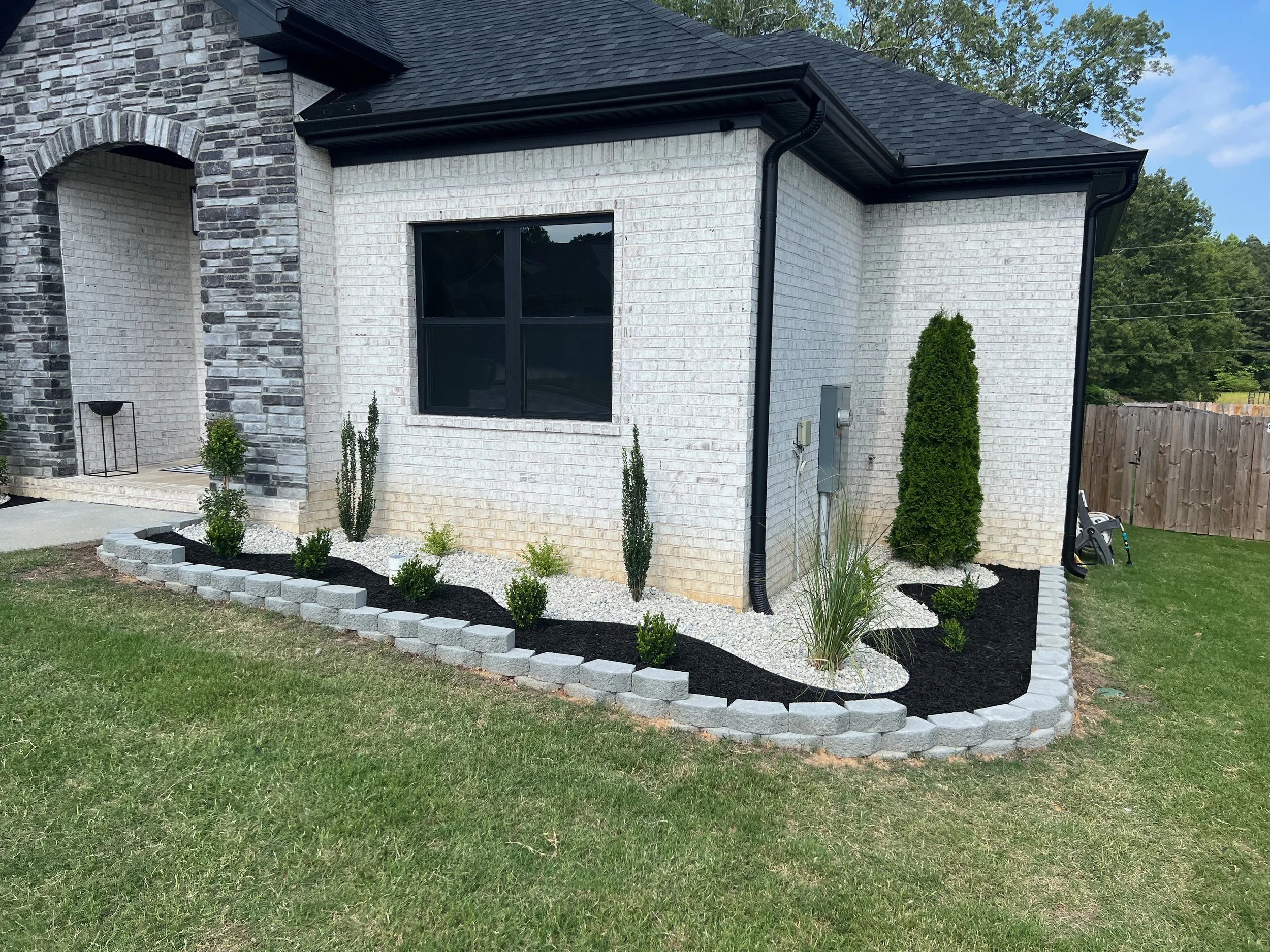 Modern Black Mulch With White Rock and Grey Block Border Landscaping