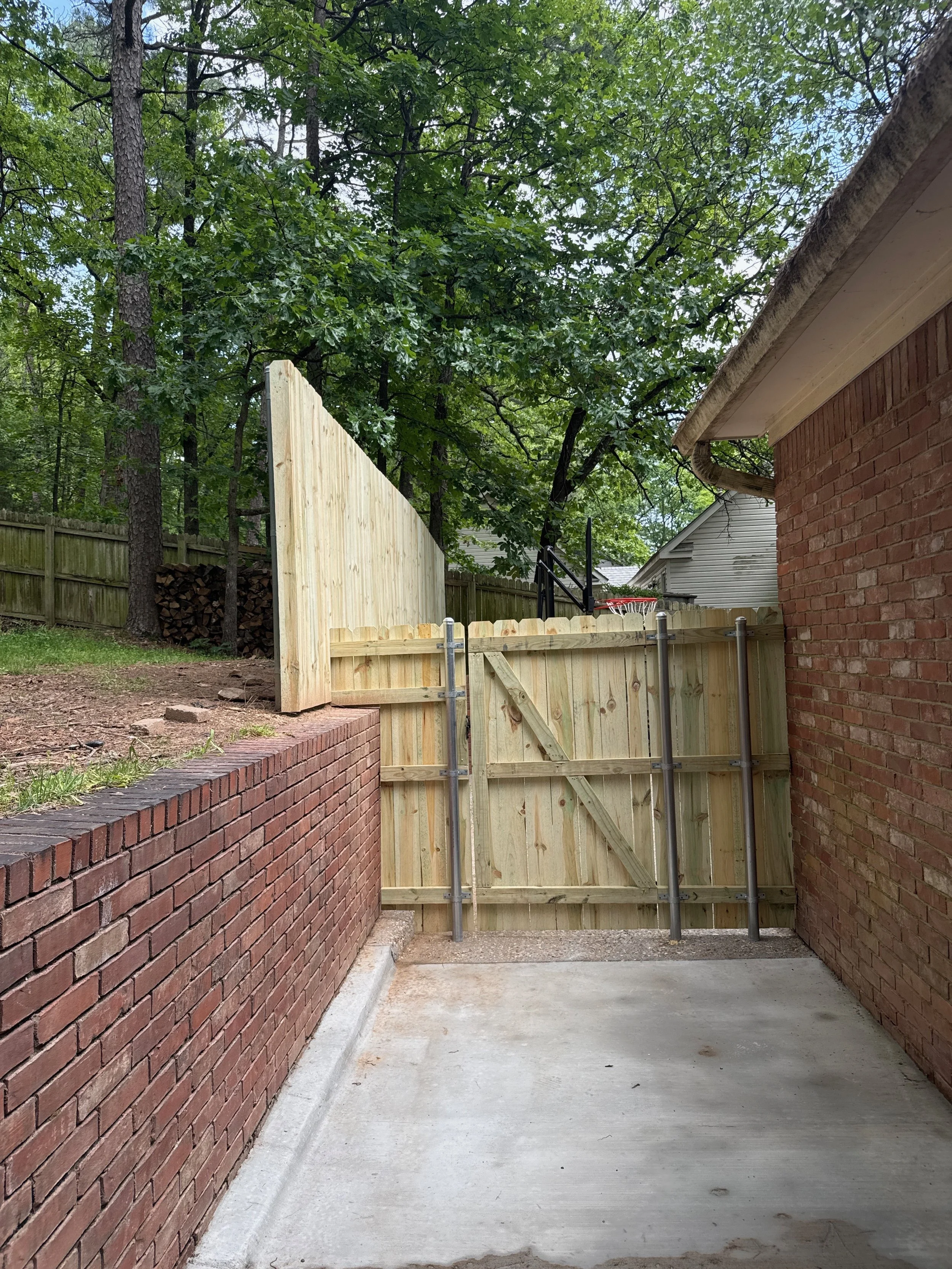Gate Install With Metal Posts Integrated Into River Rock Concrete Pour