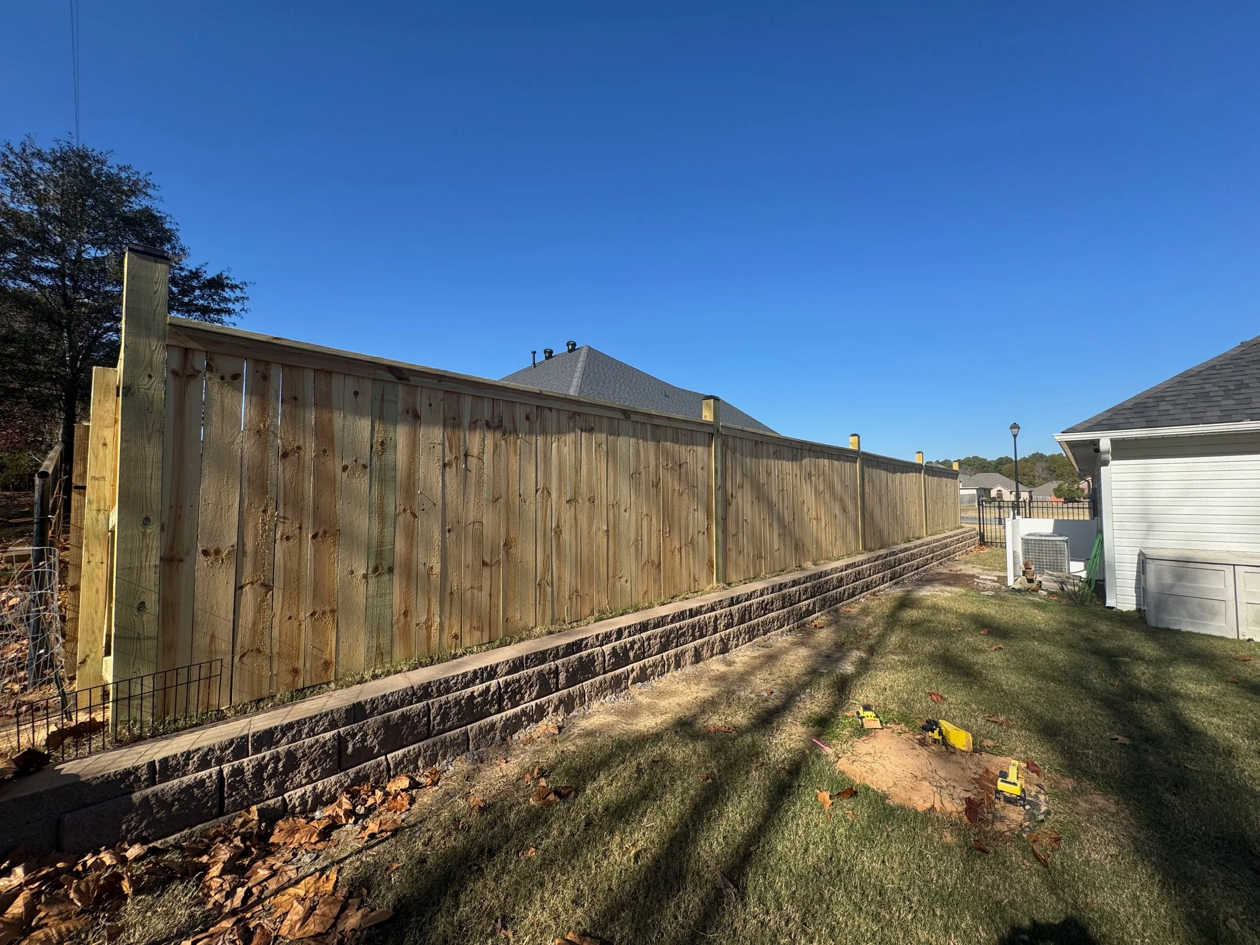 Retaining Wall Install With Premium Grade Cap and Trim Privacy Fence With Decorative Posts