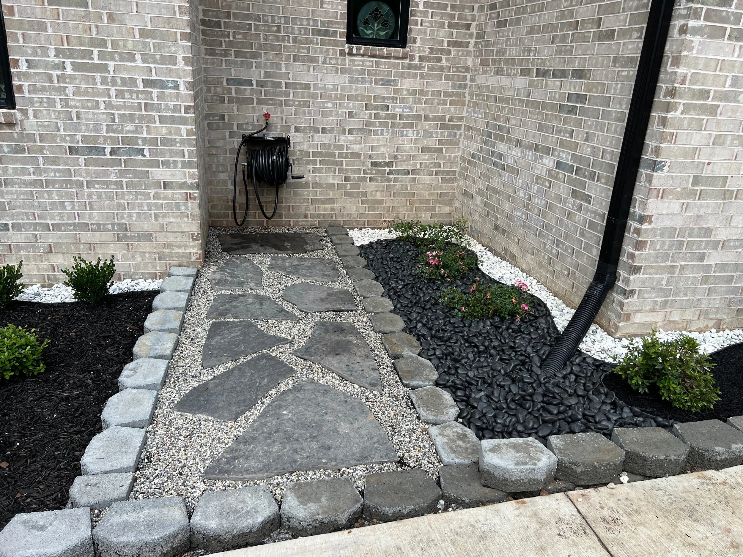 Modern Flagstone Walkway and French Drain With Black Rock Cover