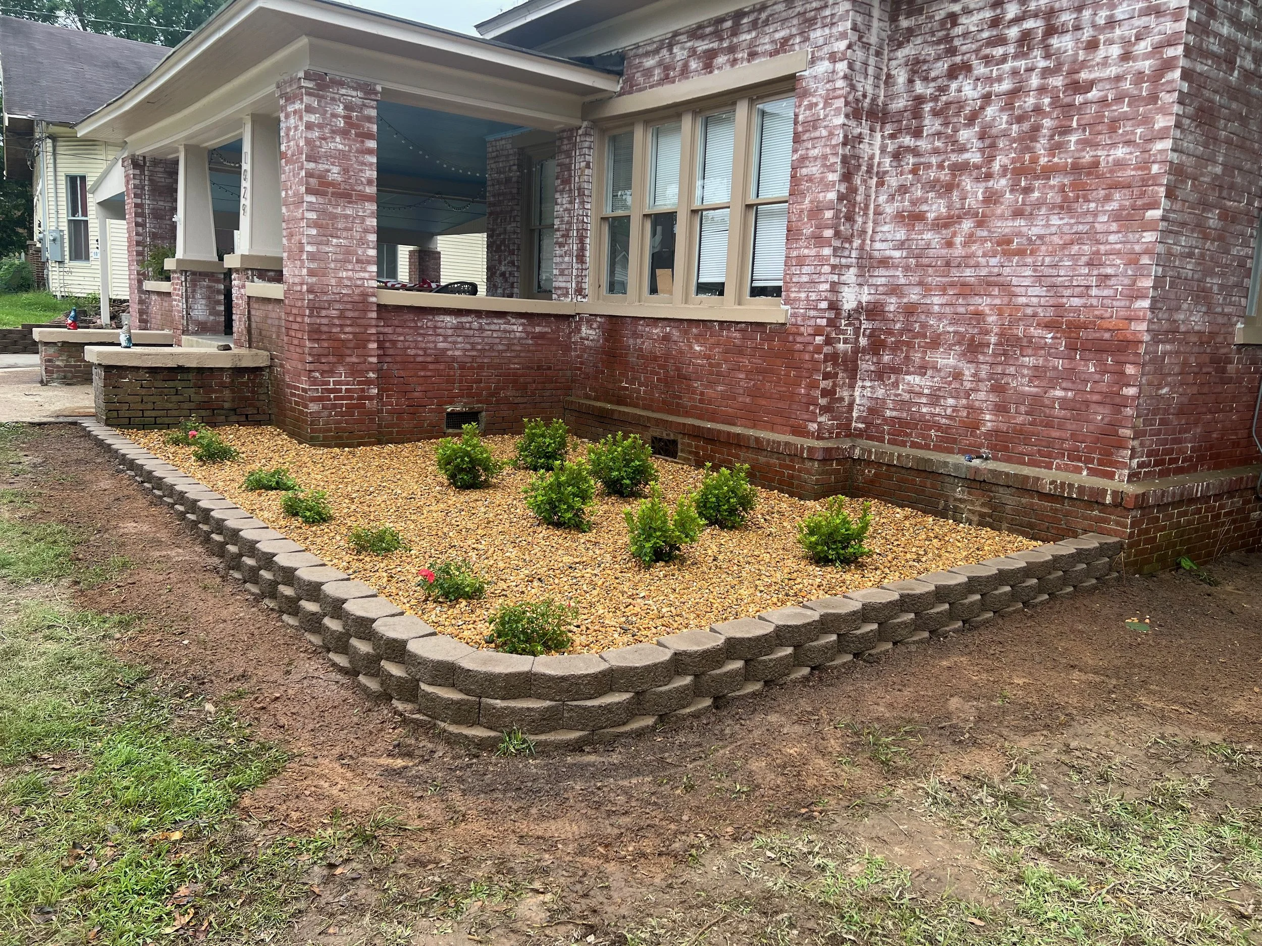 Block Border Flower Bed, New Shrubs, And River Rock Install With French Drain Along House