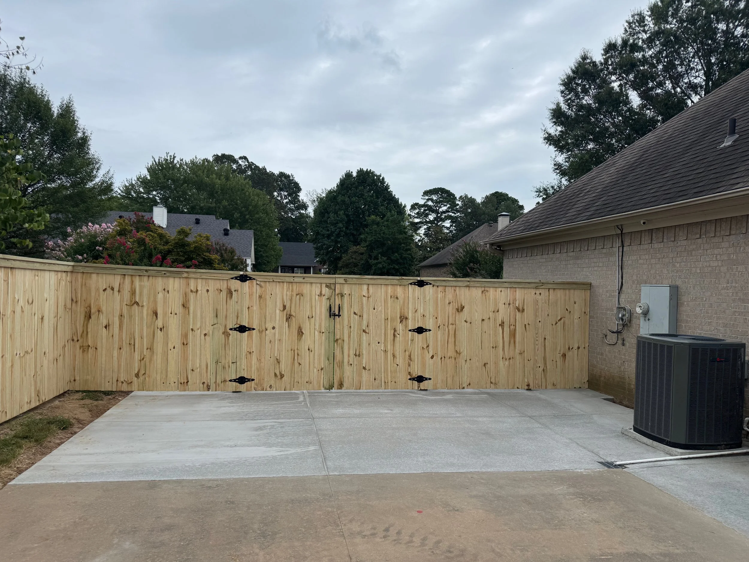 Concrete Driveway Extension With Cap and Trim Double Gate Integrated Into New Concrete