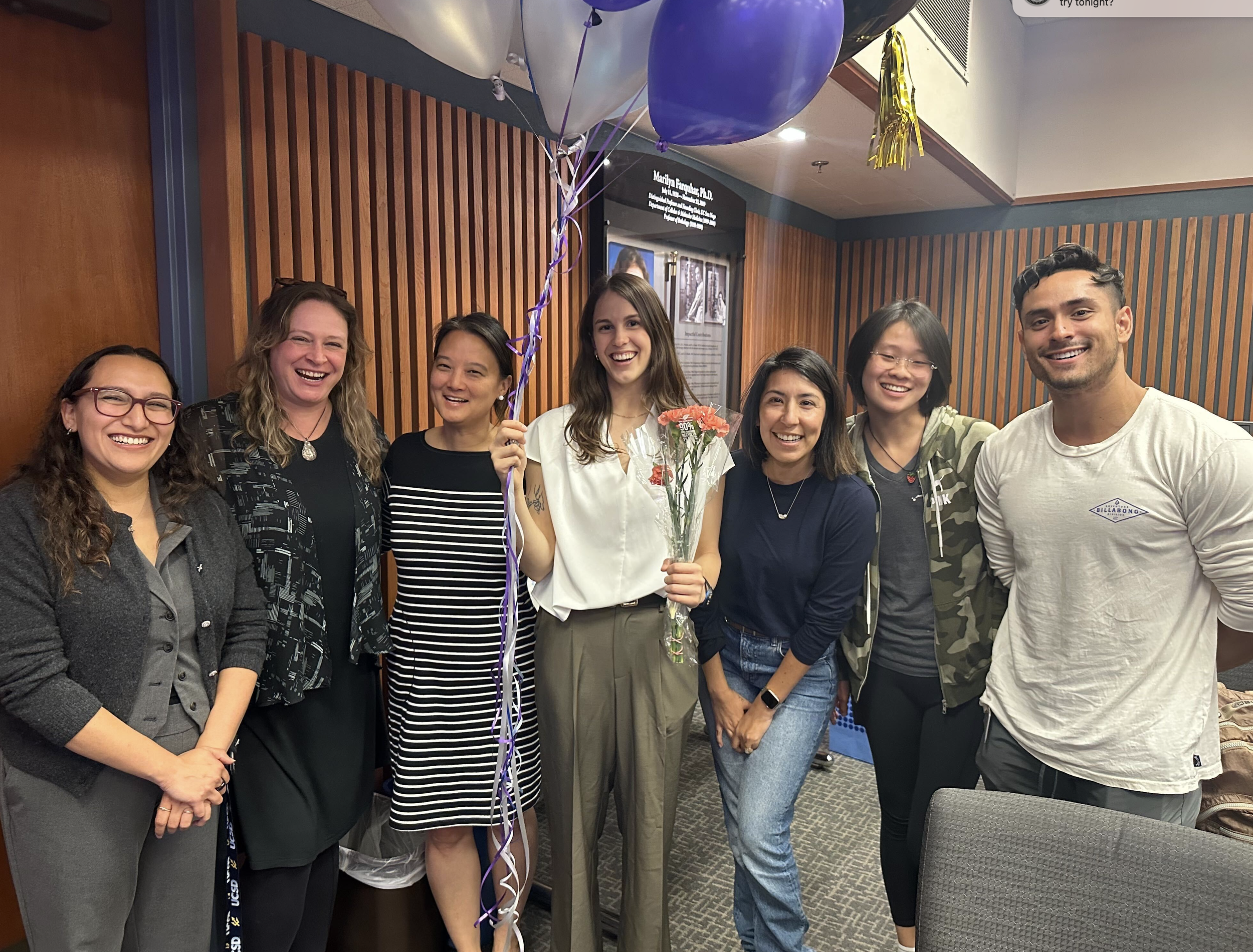 Dr. Joanna Eckhardt receives her well-deserved flowers and balloons after successfully defending her thesis!