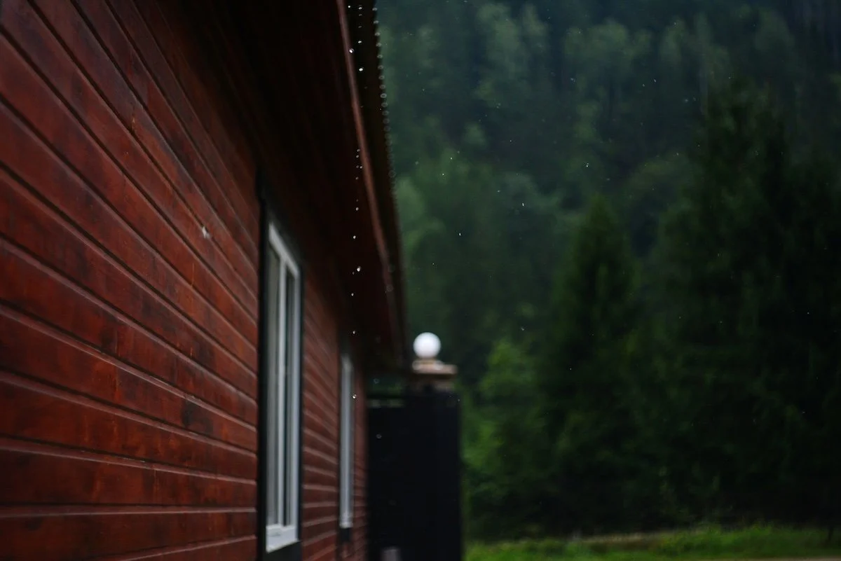 side view of house with rain drops coming off the roofline