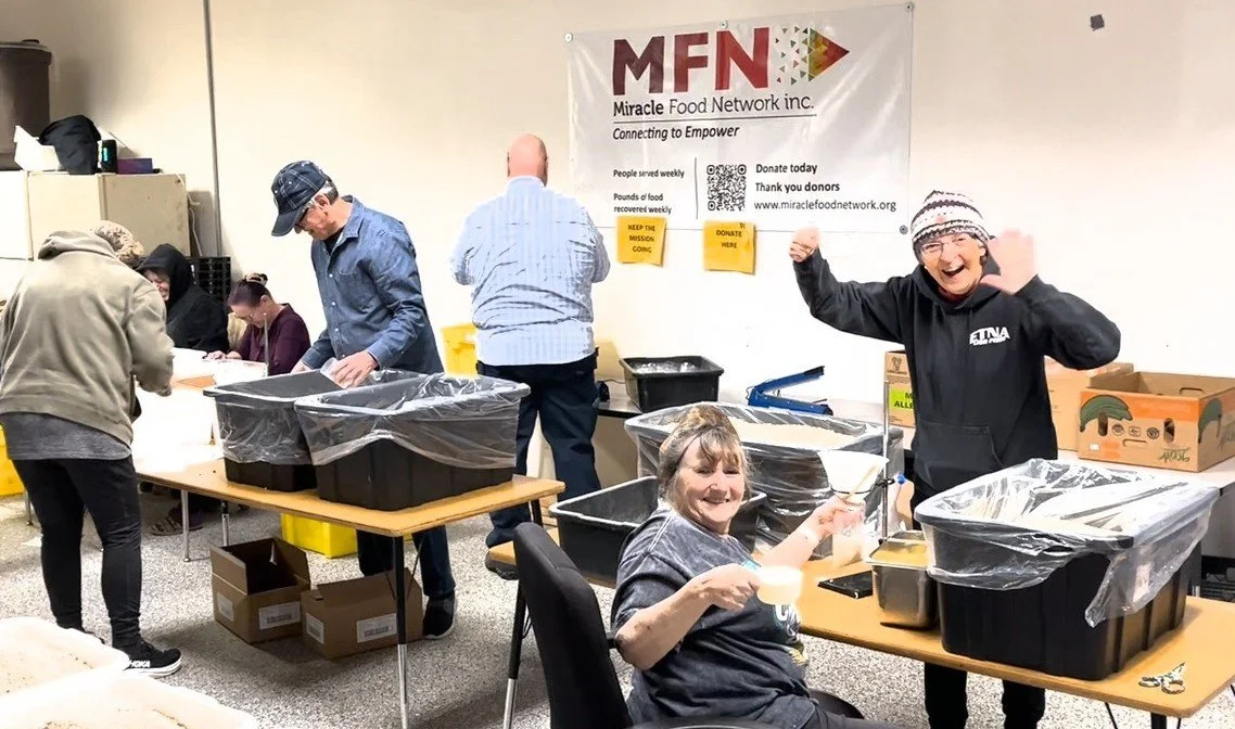 Volunteers packaging Nobody Goes Hungry dry stew mixes.