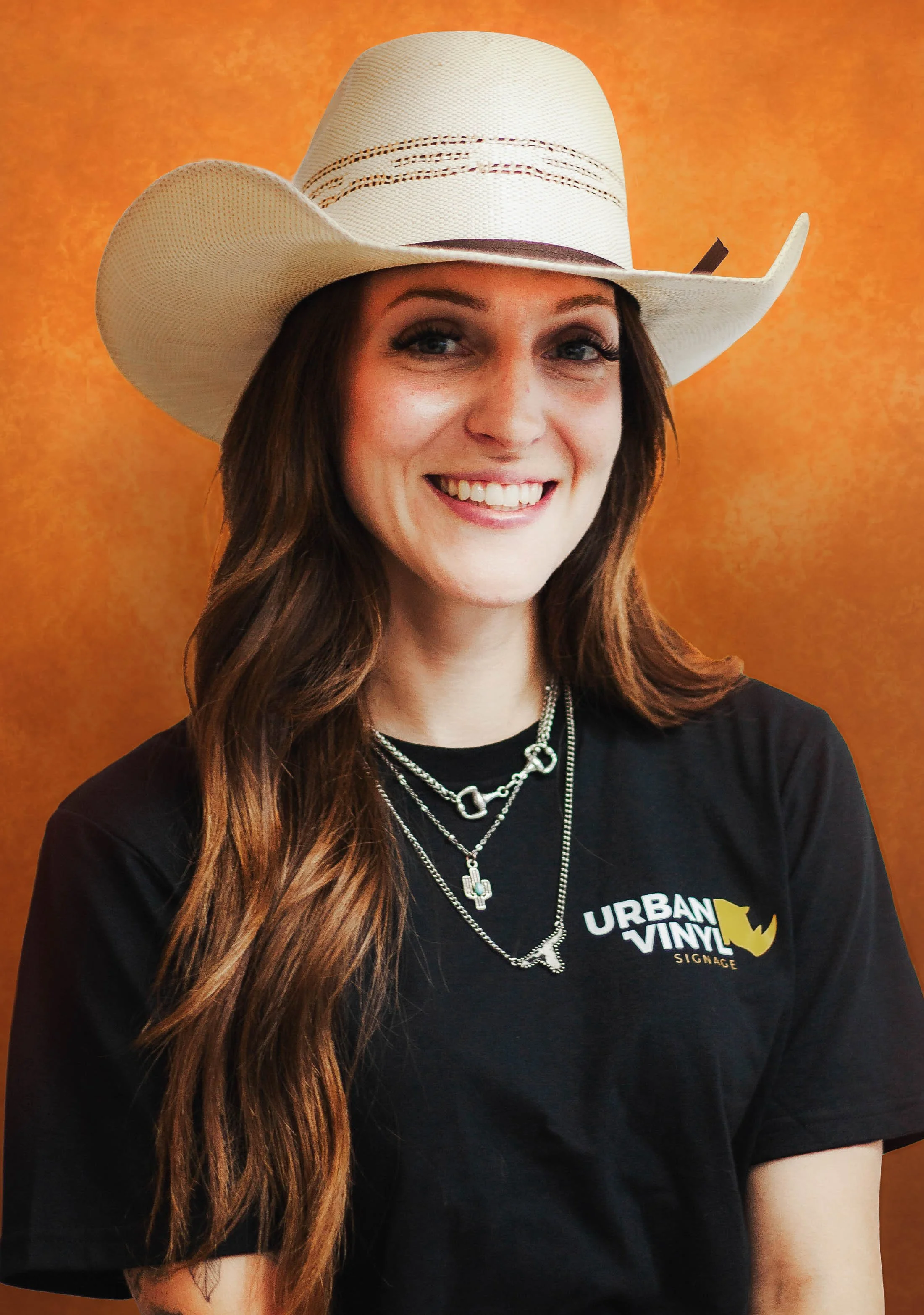 Woman with cowboy hat and necklaces