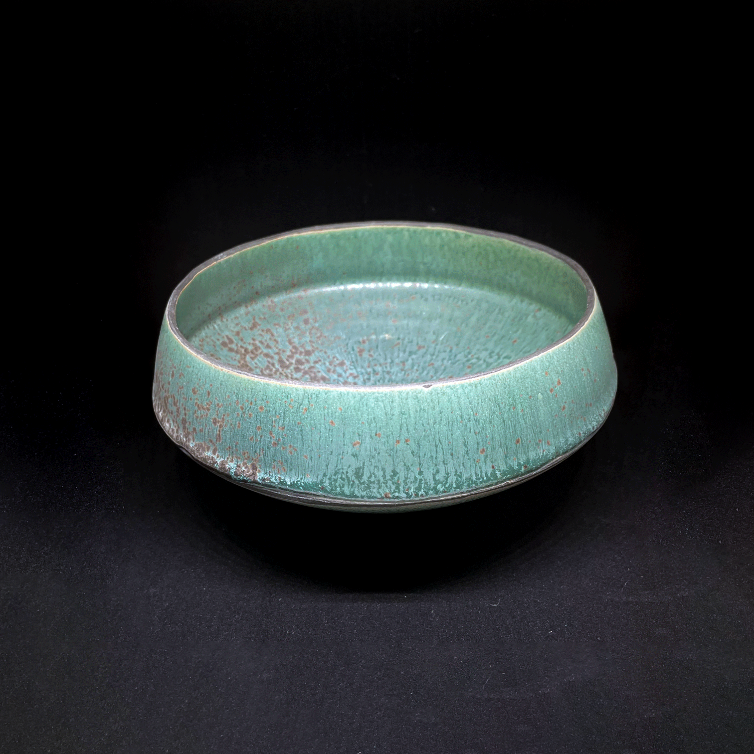 "UFO Bowl." Laura's Turquoise with black matte underglaze on SW48. 2024.