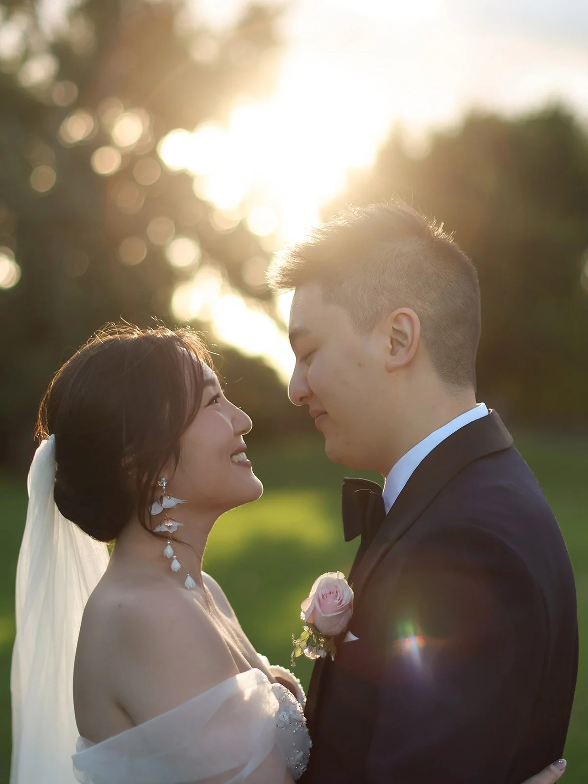 Bride and groom embracing at golden hour during their Melbourne wedding portraits.