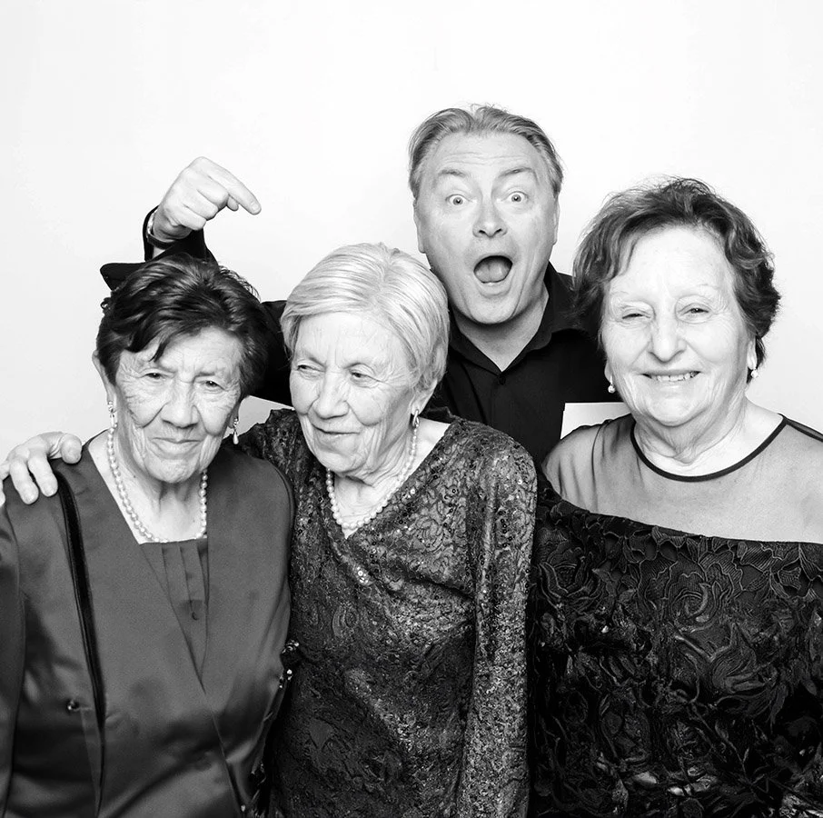 John Warren, Melbourne wedding photographer, laughing in a photo booth with three Nonnas at a wedding — fun, candid, natural moment.