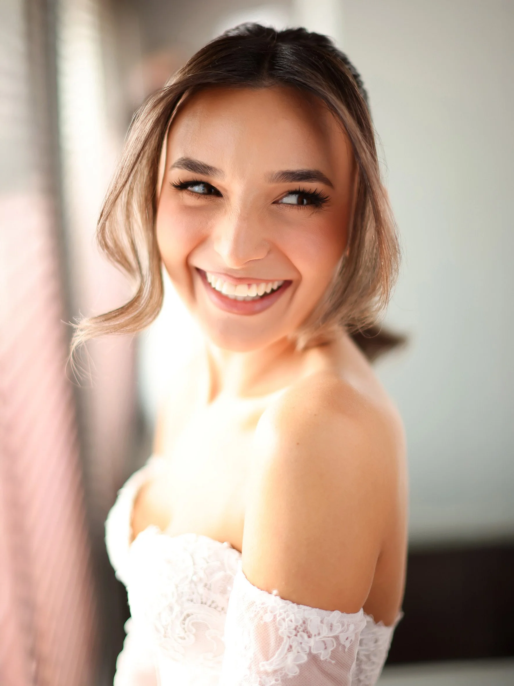 Soft natural-light bridal portrait of Nicola in window light, candid Melbourne wedding photography style.