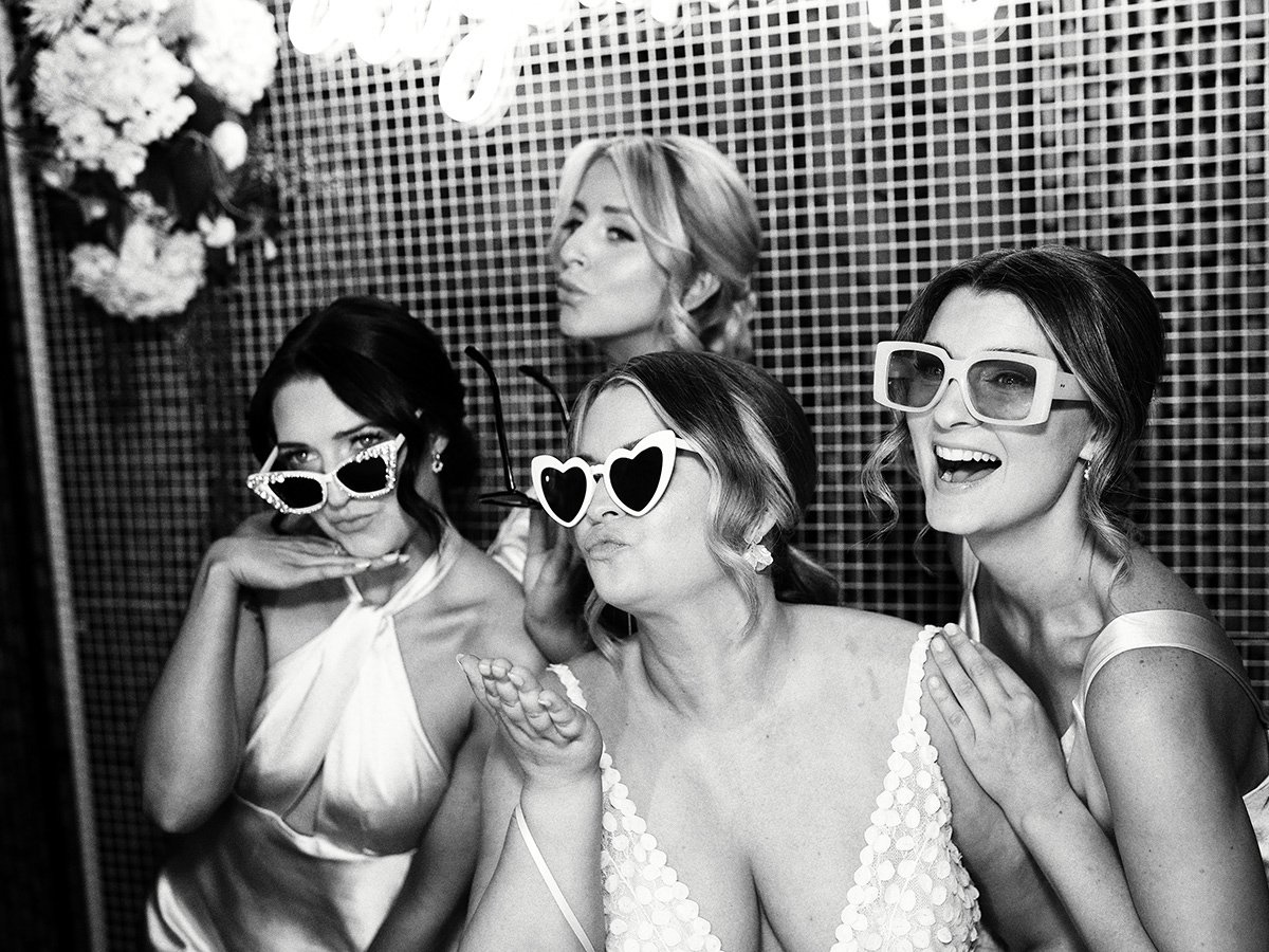 Bridesmaids laughing in sunglasses during a fun candid moment at a Melbourne wedding.