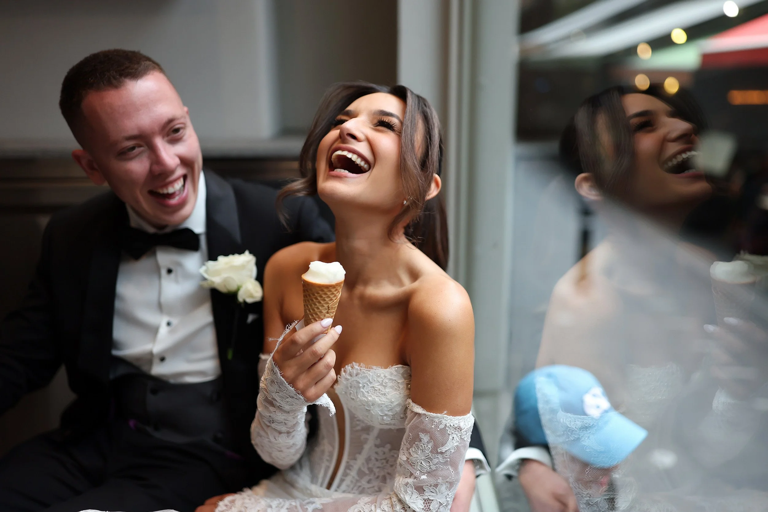 Bride and groom laughing together while sharing ice cream, fun candid Melbourne wedding photography.