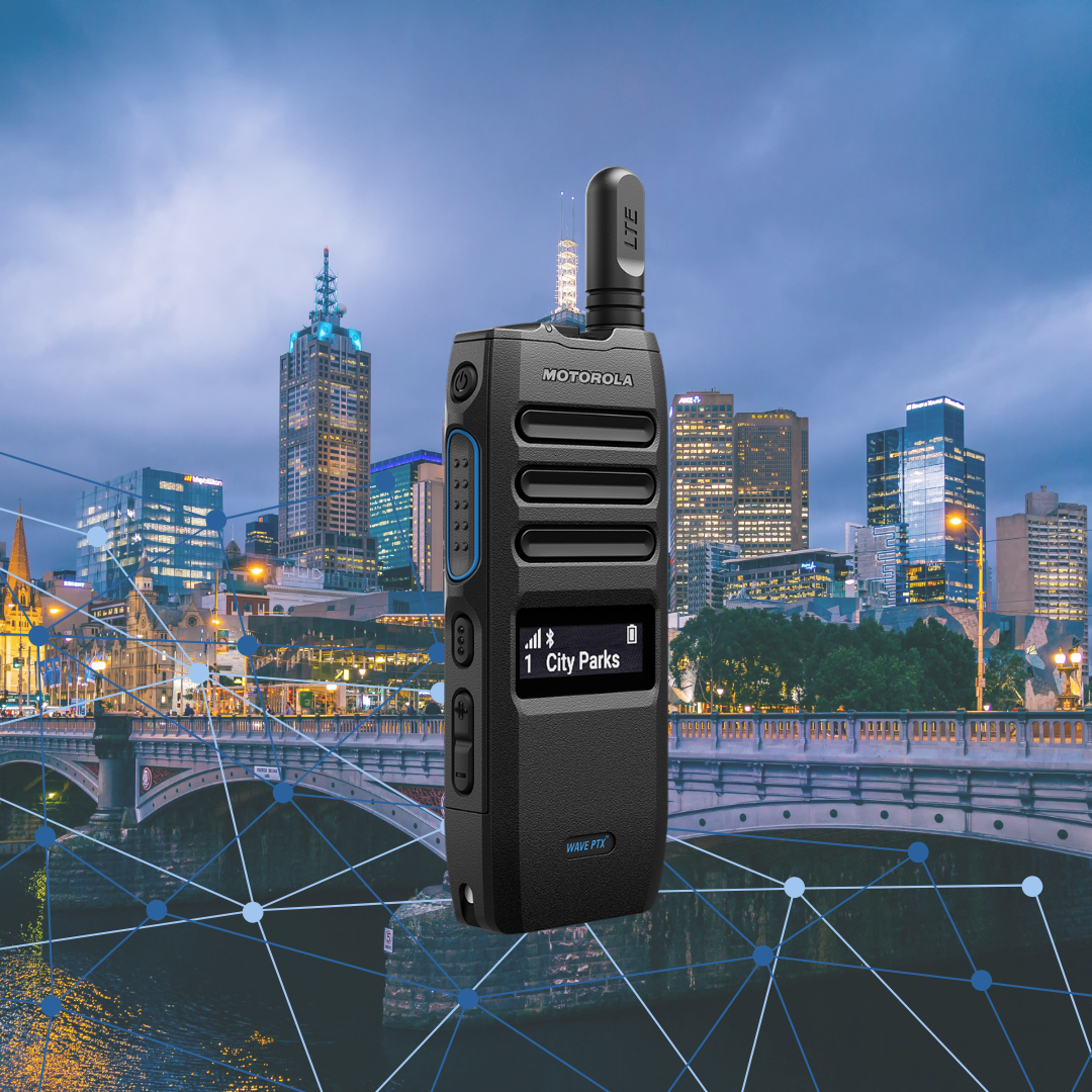 A black Motorola TLK110 Push-to-Talk over Cellular (PoC) radio overlaid on a twilight Melbourne city skyline, featuring blue digital network lines to represent city-wide fleet connectivity.