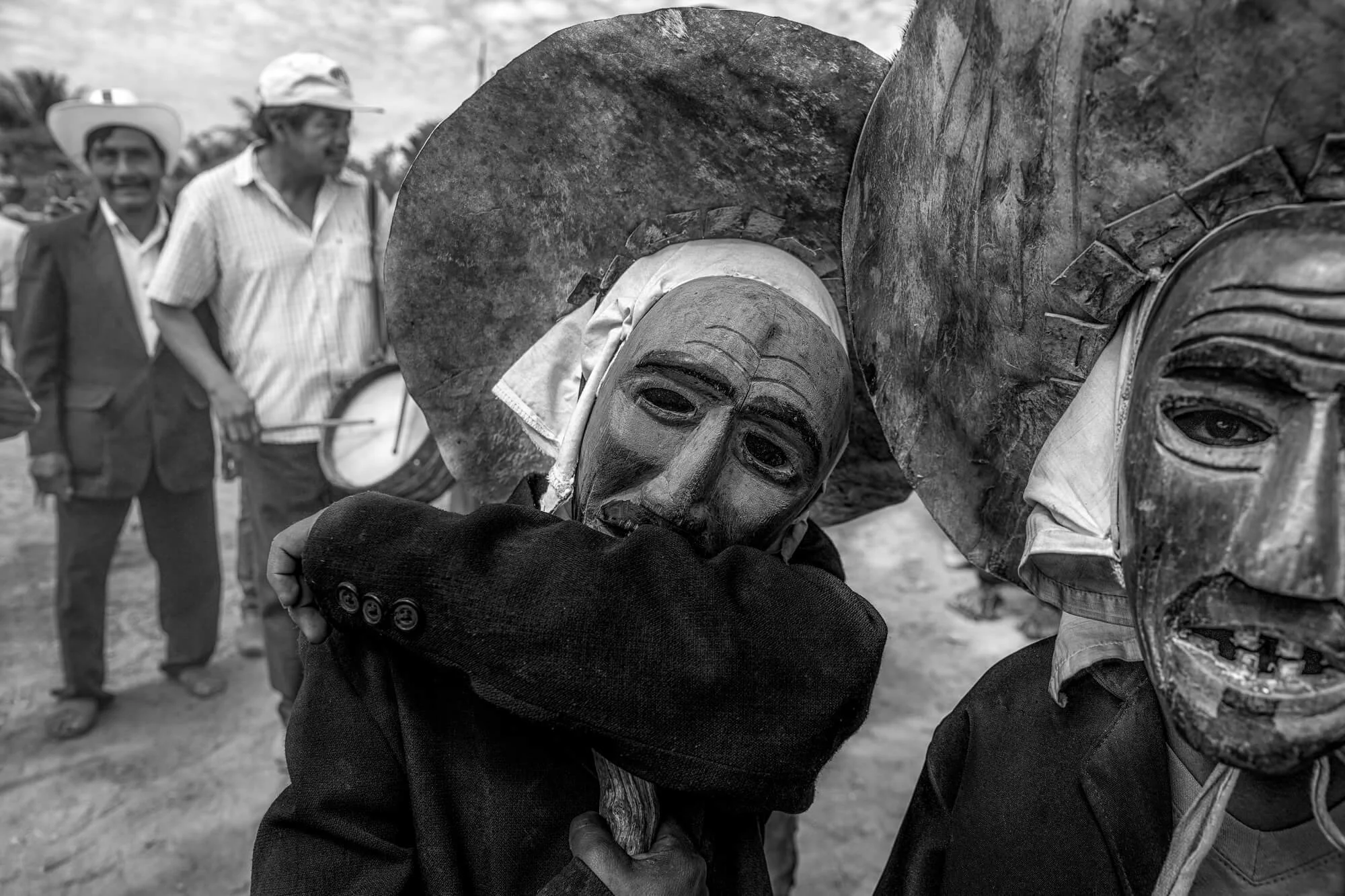 black and white photo of two people wearing  masks